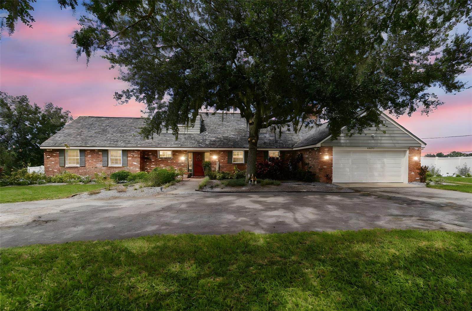 Your private oasis near the Heart of Dade City, tucked away on just over 2.5 acres, yet only minutes from downtown Dade City and the exciting new Double Branch Master Planned Development. Discover 33937 St. Benedict Rd in charming San Antonio. This one-of-a-kind, move-in-ready property offers the perfect balance of peace, privacy, and convenience. Outdoor living at its finest, step out to the expansive travertine lanai-partially covered for year-round comfort-where you can watch the big game, fire up the grill, or bask in the sun before cooling off in your sparkling pool. The property is framed by beautiful oak trees and designed for all your hobbies, from homesteading to recreation. Enjoy fresh harvests from your LEMON and BANANA TREES, gather eggs from your own CHICKEN COOP (chickens included, if you wish!), or put your tractor to rest under the covered POLE BARN. A separate SHED provides even more storage for tools and toys. And with no nearby neighbors, you’ll love the serenity of being the only home on the street.
Moving on to the spacious & stylish interior, the inside boasts 3,600 sq. ft. of thoughtfully designed living space and welcomes you with warmth and character. Highlights include: 5 generously sized bedrooms (including a downstairs owner’s suite and guest suite); 3.5 bathrooms for convenience and comfort; A family room with vaulted, exposed-beam ceilings and a cozy wood-burning fireplace; Separate living and dining rooms; a dedicated office nook; and Ample storage with organized closets throughout. The remodeled kitchen is the heart of the home, boasting quartz countertops, soft-close cabinetry with pull-out organization, glass-paneled uppers, and a spacious pantry-ideal for bulk storage.
Recent Updates For Peace of Mind: Brand NEW ROOF (2025) with transferable 50-year warranty, 2025 & 2021 A/C systems, PROPANE STOVE, DOUBLE-PANED, SPLIT DOWN windows (for easy cleaning!), NEWER WATER HEATER (2021), Extra INSULATION (2020), and 5 1/4” BASEBOARDS for a polished touch.
The Best of Both Worlds with agricultural zoning, this property welcomes your animals and homesteading dreams—all while being free of city taxes. Conveniently located just 35 miles from Tampa, 60 miles from Orlando, and within easy reach of the Gulf beaches, you’ll have quick access to I-75 while still enjoying a peaceful, country lifestyle. Come see this slice of paradise for yourself—you won’t want to leave!