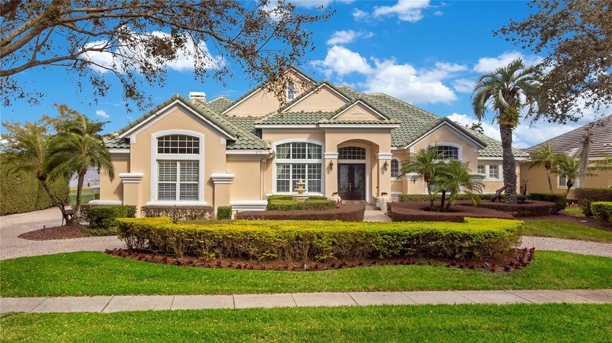 Take a look at this rare opportunity to own this custom lakefront estate in the guard gated neighborhood of Phillips Landing in Dr. Phillips. Be ready to be captivated by the panoramic breath taking lake views from the moment you enter this one level five-bedroom, five full bathroom pool home just under 5,000 heated square feet with a 3 car garage. This west facing home has a stately curb appeal with its half-moon paver driveway and timeless Mediterranean architecture surrounded with lush, manicured landscaping. Upon entry you will immediately notice the “WOW” factor with vaulted ceilings above the formal living, spectacular views, and a dining room for those special occasions with an adjacent 50+ bottle wine cellar. The spacious open floor plan with soaring 14 foot ceilings offers the best living & entertaining with rooms adorned with Crema Marfil marble floors, elegant light fixtures, and breathtaking panoramic views of Big Sand Lake. The kitchen is fully equipped with solid wood cabinetry, Kitchen Aid commercial style stainless steel appliances, vented hood, premium quartzite counter tops, center island, breakfast bar, and plenty of storage space. Your spacious primary bedroom suite boasts wood floors, a large portrait window, an enormous California style walk in closet, spa like bathroom with dual vanities, stone shower, and a jetted tub.  Secondary en-suite bedrooms are all spacious with their own closets and bathrooms. Invite your friends and family over for a game night in your own private great room/billiards room which includes a custom bar fully equipped with a beverage refrigerator and ice maker.  You will feel like you are on vacation when stepping out through the sliding glass doors leading to your private screened in oasis. The backyard was designed for entertaining and gathering around the pool, dining under the lanai, barbecuing from the summer kitchen, or just relaxing in your large pool and spa. There is plenty of space in the backyard to enjoy the lake with over 115 feet of pristine shoreline. Big Sand Lake offers you an amazing lake lifestyle to enjoy over 1,000 acres of spring fed lake including skiing and fishing activities. The sellers are putting in a brand-new dock for you at their own expense. Permit has already been approved and the construction of the new boat dock with lift is underway. Phillips Landing is 24-hour man gated, includes a park, playground, short distance to the famous Dr Phillips Restaurant Row, shops, Trader Joe’s, Publix, Whole Foods, golf courses, areas parks & attractions, airport, and great schools. Don’t miss out on this extraordinary lakefront property waiting for you. Be sure to click on the virtual tour links. 

<iframe width='853' height='480' src= https://my.matterport.com/show/?m=pxX8k9tMrDA&mls=1
></iframe>