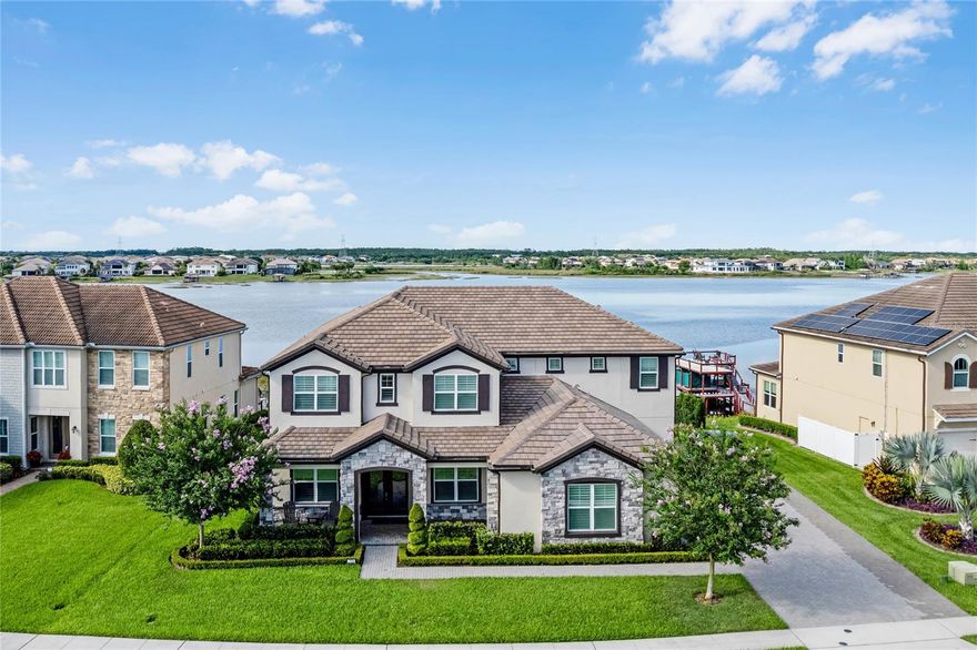 Experience unparalleled luxury in this stunning lakefront pool home, offering over 5,000 square feet of exquisitely designed living space. This residence features 6 spacious bedrooms, 5.5 bathrooms, and a private boat dock. Upon entering, you are welcomed by soaring ceilings, an abundance of natural light, and high-end hardwood flooring throughout. The open-concept design seamlessly integrates the living areas, providing breathtaking water views from every angle. The main level boasts an oversized office with elegant glass French doors and ample natural light, complemented by a formal dining room. The gourmet kitchen is a chef’s dream, complete with a 12-foot island, stainless steel appliances, extensive cabinetry, and luxurious quartz countertops. The adjoining living room and grand piano area create a perfect space for entertaining. The primary suite on the main level offers expansive water views, abundant natural light, and a lavish en suite with dual vanities, a spacious walk-in shower, and a custom closet. This level also includes an additional bedroom, a full bathroom that serves as a pool bath, and a guest half bath. Upstairs, an expansive loft provides elevated lake views and features a hidden bookshelf leading to a private movie theater room with surround sound and seating for the whole family. This level includes four bedrooms: two share a hallway bathroom, while the other two have en suites, including a second primary suite. The backyard is an entertainer’s paradise, with a covered outdoor kitchen equipped with high-end appliances, luxurious countertops, and an oversized grill. Enjoy the saltwater pool, spacious spa, ample seating, and a pergola for outdoor dining. The lower level is ideal for sunbathing with picturesque lake views. The private dock, featuring a boat lift and lounge area, is perfect for enjoying fireworks or the evening breeze. Whether you enjoy boating, fishing, water sports, or simply relaxing by the water, this home offers it all. Nestled in the well-established community Hamlin area, this property enjoys an enviable location close to major highways, ensuring convenient access to all amenities. Just minutes away, residents can indulge in excellent shopping opportunities, dine at a variety of luxury and casual eateries, and explore nearby theme parks for entertainment. The neighborhood benefits from proximity to brand-new, state-of-the-art hospitals and a top notch school system, providing peace of mind for residents seeking quality healthcare services and high end education for their family. Whether it's shopping, dining, entertainment, education, or healthcare, this vibrant community offers an abundance of options to suit every lifestyle need and preference. Call today to schedule a private tour.