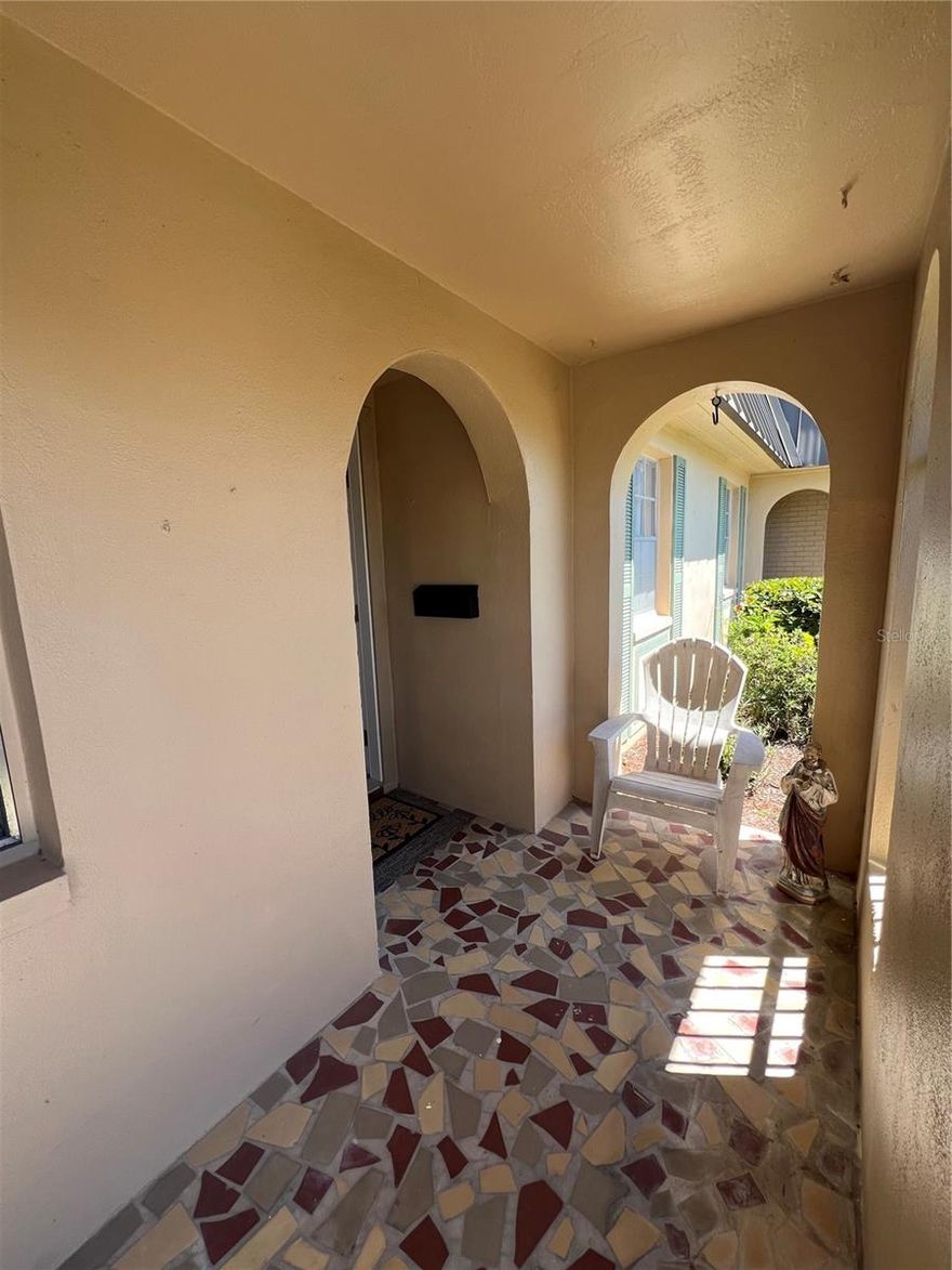 Embrace coastal living in this light-filled lakefront condo in a desirable 55+ community in New Port Richey. Enjoy tranquil water views from your private patio and nearly every room. Tile flooring throughout offers low-maintenance living, while the open layout flows from the living/dining area into a bright, window-lined family room with panoramic lake views. The updated kitchen features white cabinetry, solid-surface counters, glass-top range, eat-in nook, and pass-through to dining. Two bedrooms and one updated bath provide comfortable living, and furnishings are available for a move-in-ready option. Additional highlights include a tucked-away laundry area and covered carport. HOA includes water, sewer, trash, cable, exterior maintenance, and more. Community amenities include a heated lakeside pool, clubhouse, shuffleboard, billiards, and fishing pier.