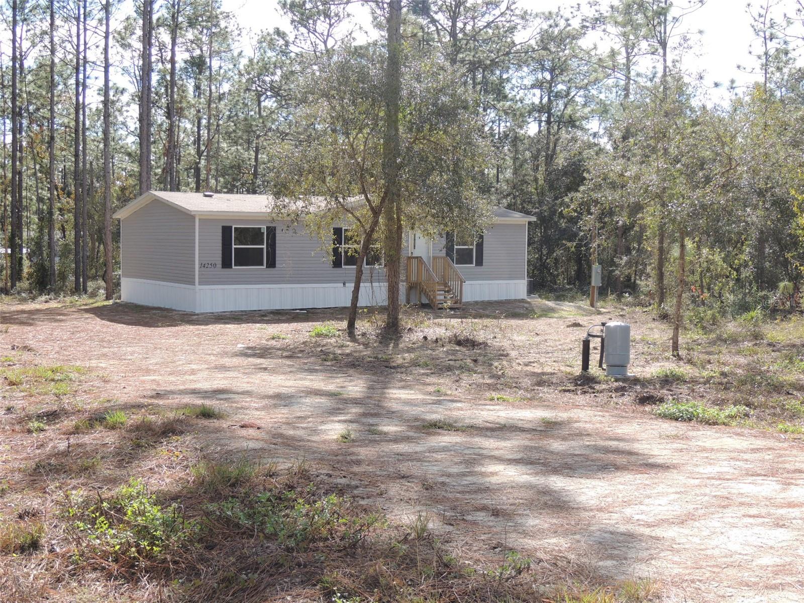 One or more photo(s) has been virtually staged. BRAND NEW AND READY FOR YOU on 1.25 ACRES!! Welcome to your dream home! This never-lived-in 3 bedroom, 2 bathroom manufactured home is perfectly situated on a spacious 1.25 acre lot. With an open floor plan, this home is designed for modern living, offering plenty of natural light through energy-efficient double-pane windows and stylish recessed lighting throughout. Enjoy easy maintenance with durable vinyl flooring in every room, while the walk-in closets in all bedrooms provide ample storage. A convenient laundry room adds to the home's practicality. The property also boasts a brand-new 4" well and septic system, ensuring peace of mind for years to come. Located in an area with no HOA and no flood zone, you’ll have the freedom to enjoy your property your way. Whether you’re looking for space to spread out, entertain, or simply relax, this home is the perfect match. Don’t miss this rare opportunity to own a brand-new home with room to roam! Schedule your tour today!