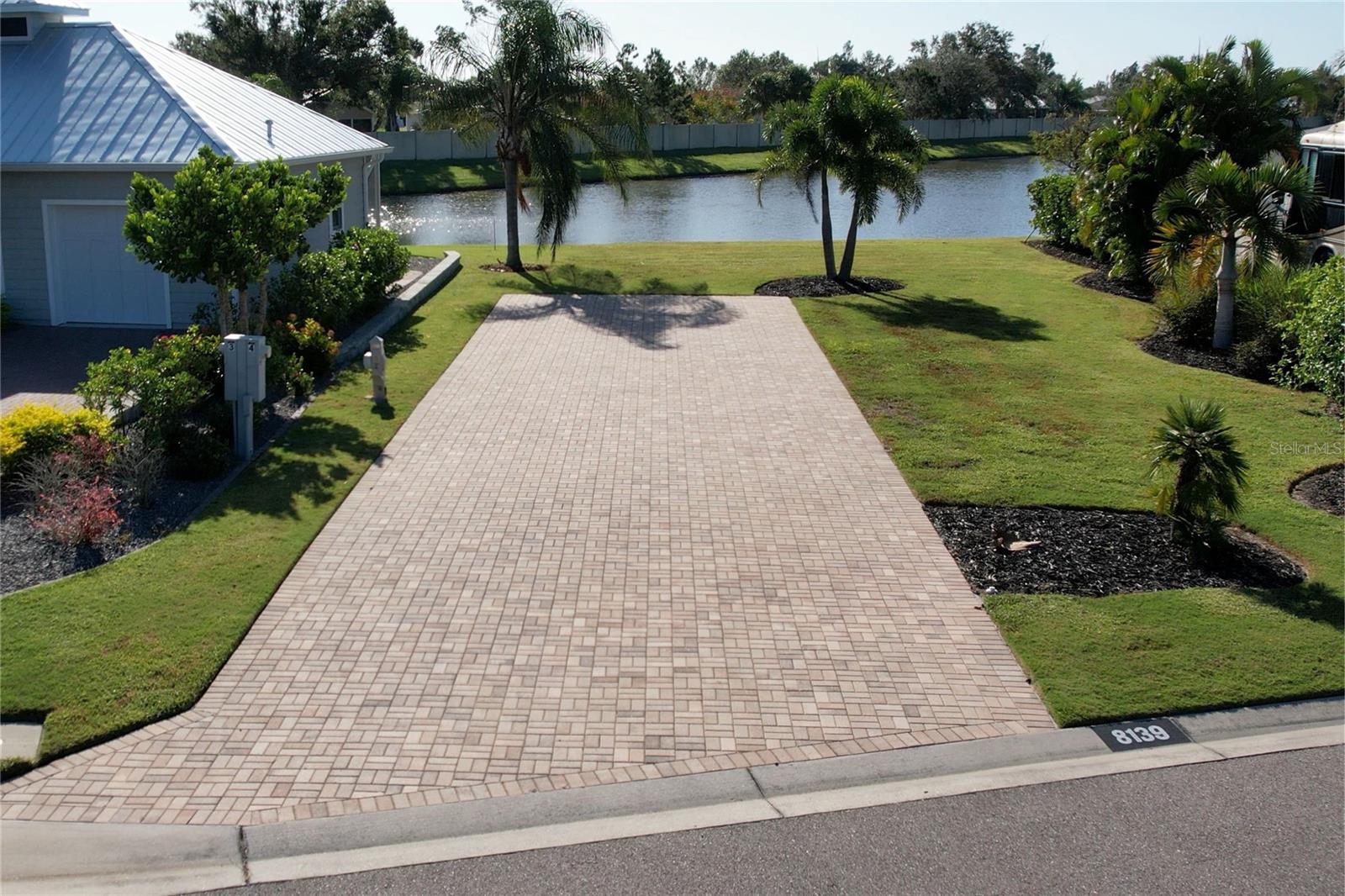 Lot 4- Double Water Views & Prime Build Opportunity!
Build your dream retreat on Lot 4, a beautifully situated property in Thornton Creek Motorcoach Resort offering captivating water views from both the front and back. With no neighbors directly in front or behind, this lot provides an open, scenic setting surrounded by lush landscaping and swaying palms.
The property features a spacious pull-in paver pad equipped with a 50-amp pedestal, providing ample room for any size motorcoach plus an additional vehicle or golf cart. You’ll also have the flexibility to build up to a 1,000 sq. ft. casita, with no immediate construction requirement—develop on your timeline and bring your vision to life.
One of the few undeveloped lots remaining in this sought-after gated resort, Lot 4 is the perfect canvas to create your ideal Florida retreat. Schedule your private tour today and start living the resort lifestyle!