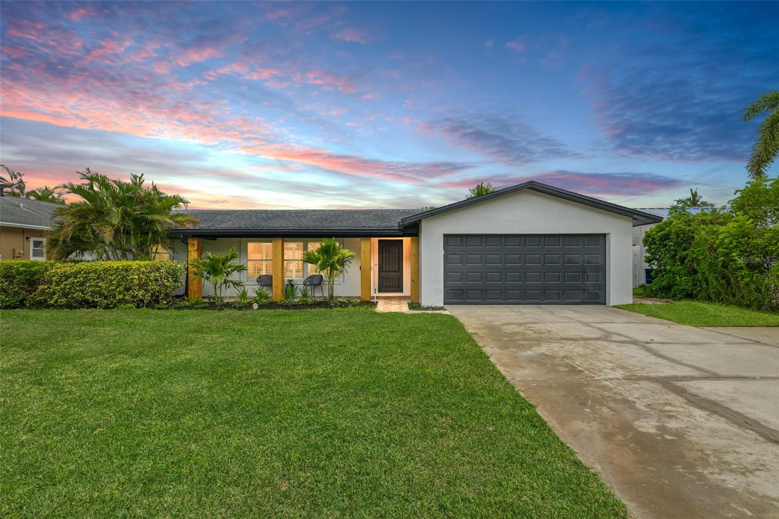 Magnificent Move-In Ready Four-Bedroom Waterfront Pool Home. This is one of those rare, needle-in-a-haystack homes that checks every box on a buyer’s wish list. From the ground up, every detail—inside and out—has been meticulously reimagined to cater to even the most discerning homeowner. From the moment you step inside, you'll be captivated by the stunning modern retreat that unfolds before you. Breathtaking water views greet you from nearly every room, while brand-new flooring flows seamlessly throughout, enhancing the home's elevated custom feel. What truly sets this property apart is its exceptional canal positioning. Unlike typical waterfront homes that face another backyard, this residence boasts unobstructed long-range views straight down the canal—delivering privacy, serenity, and the ultimate visual appeal. The open-concept living space remains beautifully intact, free from awkward patio conversions, step-downs, or unsightly ceiling beams. It’s a clean, cohesive design that maintains both form and function. Enjoy worry-free living with an array of high-end updates: a brand-new elevated HVAC system (2025), new water heater (2025), upgraded electrical, ample storage, and a fully redesigned kitchen and bathrooms. No expense was spared in transforming this rare four-bedroom, two-bath home into a modern showpiece. Set on an oversized lot, the property accommodates up to eight vehicles between the expansive driveway and garage. With no low bridge restrictions, enjoy direct Gulf and Bay large boat access from your own backyard with a private dock and 9,000 lb boat lift—perfect for boating, fishing, island hopping, or relaxing at nearby sandbars. The jaw-dropping chef’s kitchen is a dream, featuring custom cabinetry, designer lighting, brand-new Café appliances, quartz countertops with sleek hidden wireless chargers and dramatic waterfall edges. The luxurious primary suite feels like a five-star resort. Indulge in a spacious walk-in closet, a custom vanity with backlit mirror, elegant tile flooring, striking fluted tile walls with dual shower heads— all carefully curated to blend comfort with sophisticated design. Step through any of the four rear-facing sliders to your beautifully updated deck, ideal for entertaining or unwinding as you watch dolphins and manatees play in the water. The remodeled pool area is equally impressive, featuring new pavers, professional landscaping, upgraded lighting, and a tongue-and-groove ceiling—setting the scene for unforgettable evening swims or relaxed outdoor gatherings. Even the garage floor was thoughtfully upgraded with a sleek epoxy finish—no detail has been overlooked. Located in the warm and welcoming community of Ponderosa Shores—once hailed as "St. Pete’s Hidden Gem"—you’ll be just minutes from the vibrant energy of Downtown St. Petersburg. Cruise this golf-cart-friendly neighborhood, join the festive Shore Acres Holiday Parade, or enjoy a scenic bike ride along the Northeast Trail to Historic Vinoy Park and Downtown. With its unbeatable location, top-to-bottom updates, and luxurious waterfront lifestyle, this move-in ready masterpiece is a rare find. Don’t wait—schedule your private showing today and experience the pinnacle of Florida waterfront living.