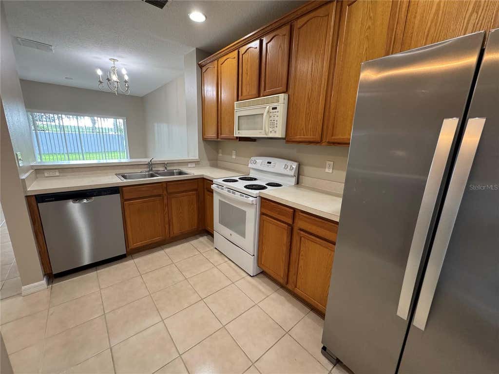 Photo of 9472 Flowering Cottonwood Road #77, Orlando, FL 32832 (MLS # O6432040)