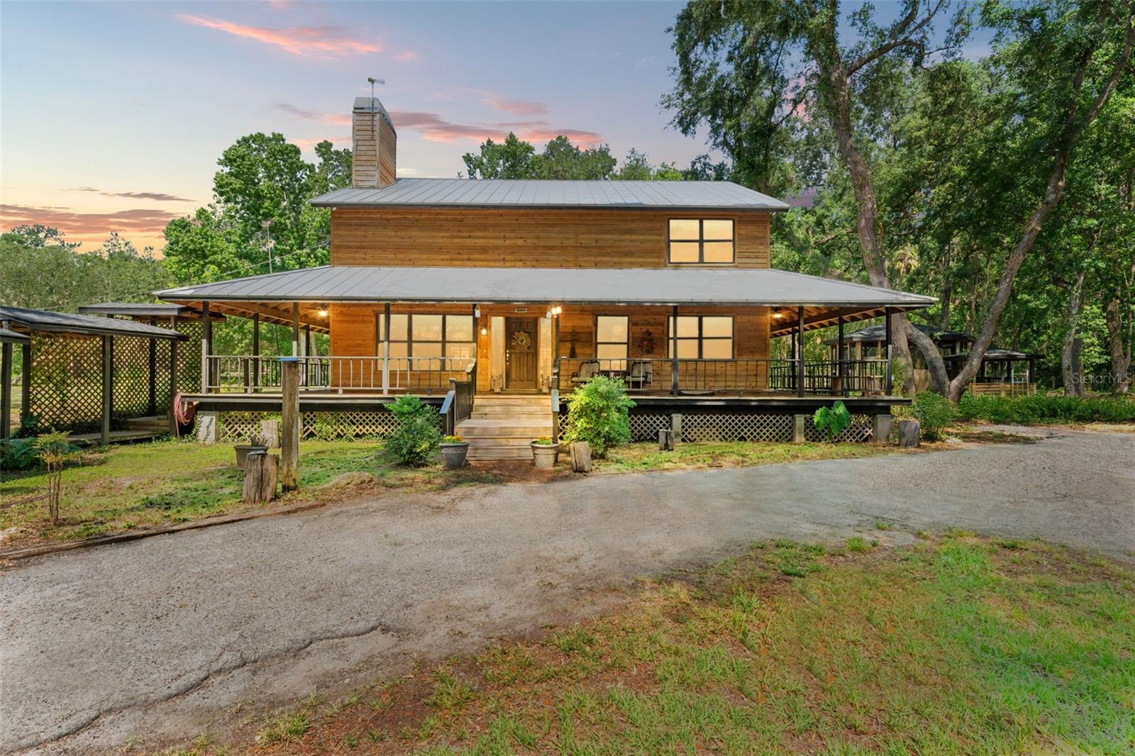 MASSIVE PRICE REDUCTION AND UP TO $30,000.00 IN SELLER CLOSING COSTS ASSISTANCE (with an acceptable contract). SELLER SAID SELL IT!!!!! Welcome to your private slice of equestrian paradise nestled in the sought-after Neff Lake area of Brooksville, Florida. Set on 9.4 beautifully maintained acres, this turnkey horse ranch offers the ideal blend of country charm, functionality, and Florida lifestyle. The main residence is a warm and inviting 4-bedroom, 2-bathroom pool home, wrapped in a classic Southern porch that captures serene views of your barns, pastures, and sunsets. Designed with rustic charm in mind, the home features a newer metal roof, updated HVAC, and a fully remodeled kitchen that opens to a cozy living room with soaring ceilings and a stunning floor-to-ceiling wood-burning fireplace. Upstairs, a spacious guest suite offers privacy with its own bathroom and additional sitting area, while the oversized master bedroom overlooks the main living space for a touch of open-concept luxury. Equine facilities include two well-ventilated barns with 12 multi-sized stalls, perfect for housing everything from show horses to stallions. There's ample space for trailer or RV storage, a tack and feed room, and generous room for additional paddocks. Five large, newly fenced pastures are already in place, with potential to expand in the rear of the property. An additional 1-bedroom, 1-bathroom guest cottage offers endless versatility—use it for a live-in trainer, family member, home office, or income-producing rental. Plus, the seller is including a brand-new utility shed—ideal for storing equipment or customizing to your needs. Additional features include: • Gated entrance • Open space for an arena • Circular drive with RV and trailer hook-up • Ample additional parking • Covered gazebo with conversion potential for an outdoor kitchen • Located just 45 minutes from Tampa International Airport and the World Equestrian Center Whether you're chasing championship dreams or simply want to live a luxurious ranch lifestyle, this Brooksville property delivers it all—comfort, capability, and character.