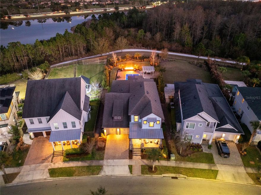 Welcome to this exceptional former model home in the highly sought after Laureate Park community of Lake Nona, perfectly positioned on a rare 0.40 acre homesite backing to peaceful conservation with no rear neighbors, offering resort style living right at home with all the bells and whistles. This beautifully designed residence combines elegant architecture, spacious living areas, and a stunning resort style backyard that creates a truly special living experience.

A welcoming covered front porch with brick paver flooring and a ceiling fan offers the perfect place to relax and enjoy the neighborhood. Inside, the home opens to a dramatic foyer with a sweeping staircase and an abundance of natural light. Wood flooring flows through the main living areas, complementing the thoughtful design and high end finishes throughout the home.

The spacious great room features soaring ceilings and a stunning wall of windows overlooking the backyard oasis and conservation beyond. This open concept living space connects seamlessly to the dining area and chef inspired kitchen, creating an ideal setting for both everyday living and entertaining. The kitchen offers granite countertops, a large center island with seating, stainless steel appliances, double ovens, a vented range hood, and a walk in pantry.

The private primary suite provides a relaxing retreat and showcases beautiful wood flooring, a striking coffered ceiling with exposed beams, and large windows that frame views of the pool and backyard. The spa inspired ensuite bathroom features dual vanities, a large soaking tub, an oversized walk in shower with decorative tile accents, and a generous walk in closet.

A dedicated home office near the front of the home offers a refined workspace with decorative wall paneling, crown molding, recessed lighting, and wood flooring, making it ideal for remote work or study.

Upstairs, a spacious loft overlooks the living area below and provides a flexible second living space perfect for a media room, lounge, or play area. Additional bedrooms and bathrooms offer comfort and privacy for family and guests.

Outdoor living is equally impressive. Step outside to a true resort style backyard designed for entertaining and relaxation. The expansive outdoor space features a stunning custom pool with sun shelf loungers, a raised spa with spillover, and an oversized deck that creates multiple areas for gathering and lounging. A dramatic linear fire feature provides a beautiful focal point for evening gatherings, while the pergola covered lounge area offers additional shaded seating. Surrounded by lush landscaping and backing to tranquil conservation, the backyard offers exceptional privacy and breathtaking sunset views.

Laureate Park isn’t just a neighborhood it is a vibrant lifestyle. Enjoy the Aquatic Center, resort style pools, LP Fit gym, and more than 44 miles of scenic trails. Located in prime Lake Nona just minutes from Medical City, the VA Hospital, Nemours, dining, and shopping. Easy access to Orlando International Airport, the USTA National Campus, major highways, Orlando’s world famous theme parks, and Florida’s beautiful beaches.

This remarkable home offers luxury, space, and privacy in one of Lake Nona’s most desirable communities. Schedule your private showing today.