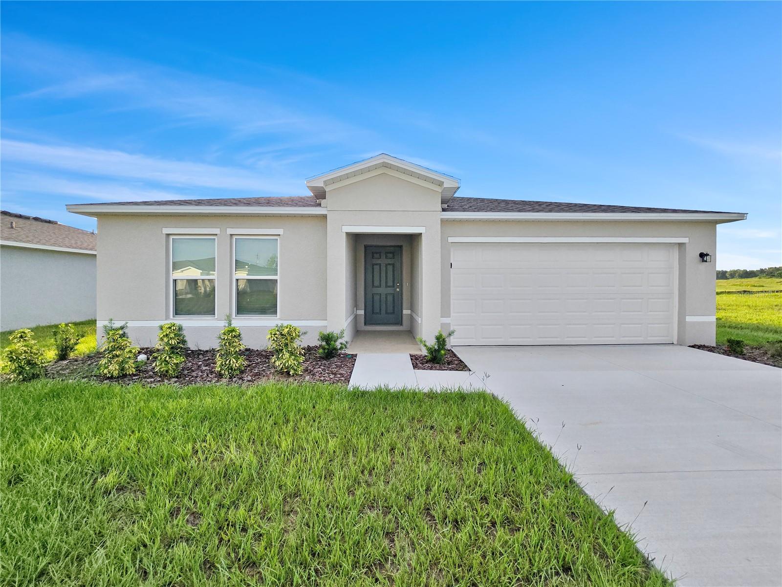 Discover this stunning 4 bedroom 2 bath new build in Belleview, FL, offering 1811 sf with an inviting open floorplan and plenty of space for comfortable living. The bright, airy layout seamlessly connects the living, dining, and kitchen areas—perfect for gatherings and everyday life. The modern kitchen boasts sleek finishes, ample cabinetry, and a spacious island. Generously sized bedrooms provide comfort and privacy, while the primary suite offers a serene retreat. Large windows fill the home with natural light, and quality craftsmanship is evident throughout. Enjoy a brand-new home with modern style, functionality, and room to grow! 2 car garage for cars and added storage.