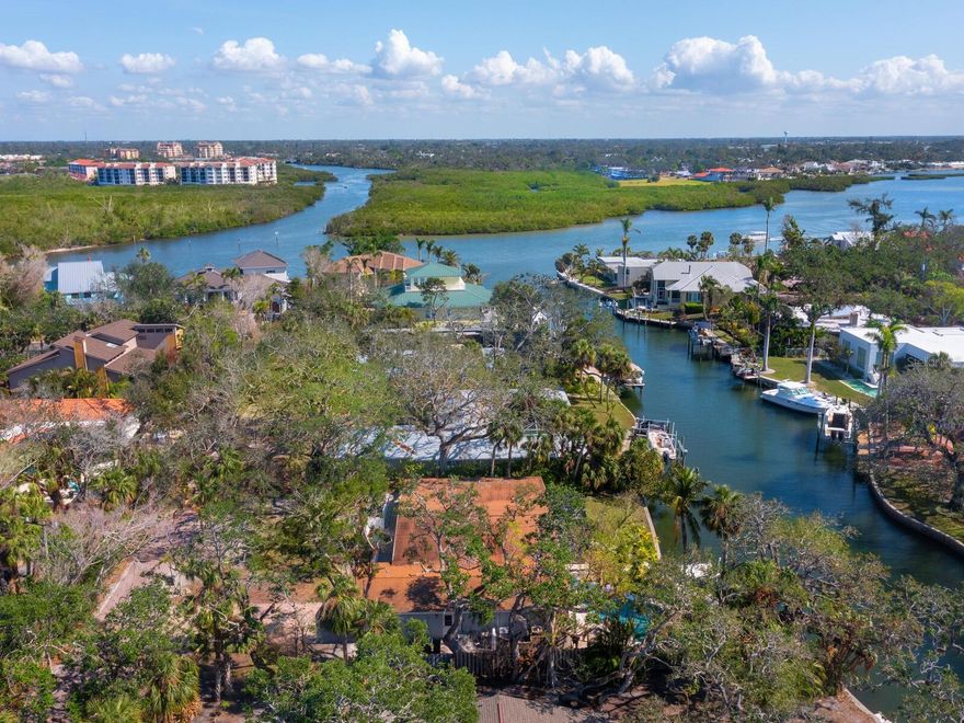 New Price! A rarely available property in Royal Palm Harbor, Siesta Key. Discover the ultimate island lifestyle just half a mile from the world-renowned, powdery white sands of Siesta Beach and the Gulf of Mexico. The nearly 18,000-square-foot lot provides endless possibilities to renovate or build your dream waterfront retreat. The home has been professionally remediated and features a sprawling layout that opens to breathtaking water views. In a private, lush, tree-canopied community, this spacious three-bedroom, 3.5-bath, two-car garage home sits on a deep sailboat water bayou, just five lots from Sarasota Bay and the Intracoastal Waterway, offering direct gulf access with no fixed bridges. French doors lead to a sparkling freeform pool, while the screened patio is surrounded by lush, tropical landscaping, the ideal setting to enjoy Florida’s stunning wildlife and serene sunsets. Boaters will love the 111 feet of seawall, offering plenty of space to dock a power boat or sailboat. Whether you choose to launch a kayak, paddleboard or cast a fishing line from your backyard, this location is ideal for water enthusiasts. Ideally minutes from Siesta Village, you'll enjoy charming restaurants, boutique shopping and vibrant nightlife. Plus, downtown Sarasota’s arts and entertainment scene is just a short 15-minute drive. This is a rare waterfront opportunity to create your island getaway. Schedule your private tour today!