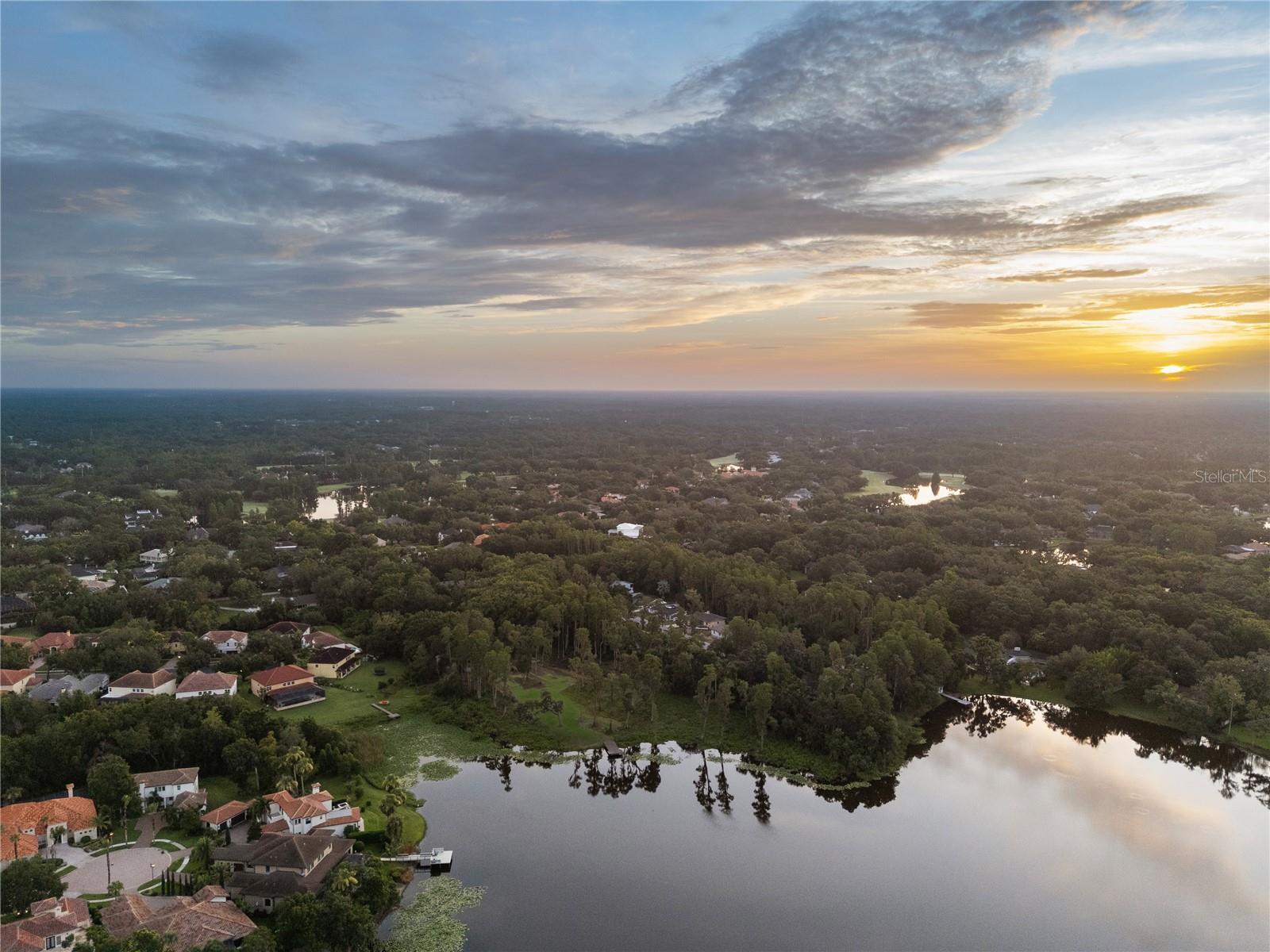 Located on the private Byrd Lake, shared in part with Avila—one of Tampa’s most exclusive neighborhoods—this rare lakefront parcel is an opportunity that has not surfaced in many years. Awake each morning to breathtaking sunrise views over this ~18-acre freshwater retreat, reaching depths of up to 16 feet, with no public access to disturb the quiet serenity. The property sits more than 400 feet off the public road, with a 25-foot-wide, 400-foot-long private driveway that opens to a secluded world of nature, where majestic bald cypress, centuries-old oaks draped in Spanish moss, and stately pines frame a setting of unparalleled tranquility. A gate at the driveway entrance ensures complete privacy, with the home site entirely invisible from the road.
Here, you’ll feel worlds away, yet remain just 20 minutes from Downtown Tampa, Water Street, and Tampa International Airport. Most of the land lies in Flood Zone X, with only minimal fringe at the water’s edge, while county setbacks protect the shoreline and docks often qualify for streamlined DEP self-certification. This expansive lot offers a rare canvas for a custom estate where modern luxury meets natural beauty—perfect for terraces, infinity-edge pools, or glass-walled living that blends indoors and out. More than just land, this is an invitation to create a legacy estate defined by privacy, prestige, and timeless elegance.