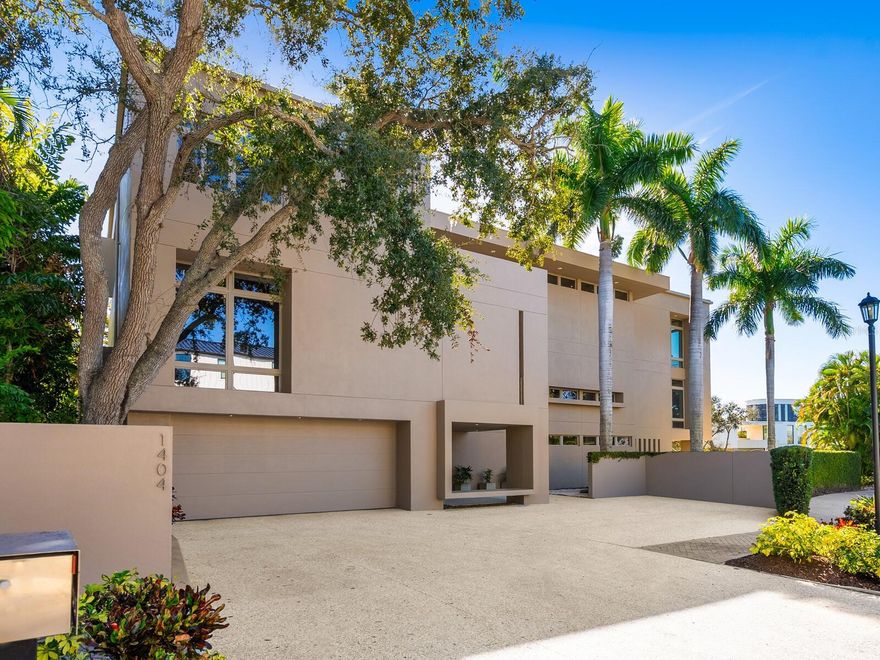 Privately positioned in gated Oyster Bay Landings with water views stretching down a short canal to Sarasota Bay, this stunning iconic masterpiece from world-renowned architect Guy Peterson is a breathtaking example of the Sarasota School of Architecture’s style and vision. A comfortable modernistic ambiance flows freely throughout the 5,428 sq. ft. of open living where walls of glass capture spectacular displays of the cerulean blue water and evening skies of fiery beauty. No detail has been overlooked. No expense has been spared. Architecturally striking, this 4-bedroom, 4.5-bath waterfront residence is the ultimate indulgence offering rarity, cachet and grandeur. Dock with 2 lifts is conveniently situated on a waterway unencumbered by any bridge. Floor to ceiling windows frame expansive vistas and abundant natural light complements the thoughtfully-appointed and expertly-planned space. Over 4,000 square feet of outdoor area is inviting and festive, and presents unique vantage points to deliver an exhilarating experience. Expansive terraces promote seamless indoor-outdoor living. Covered entertaining is abundant among the verdant tropical gardens and immaculately manicured grounds. Resort-style amenities including an elevator, courtyard with fire pit and heated pool/spa, and breathtaking reflecting pool with fountain. The stunning kitchen is a culinary delight and complemented by an extravagant amenities package of top-tier appliances, island with seating for 6, 20-ft. long counter for 2 desk workstations, side-by-side but separate refrigerator and freezer, 2 dishwashers, and deep walk-in pantry. The family room is equipped with built-in entertainment wall and opens to a waterfront patio with outdoor cooking center. The great room has travertine floors and cypress ceiling detail, and the office provides a desk with stone countertops and plenty of solid wood cabinetry. A 400-bottle wine room is the highlight of the gaming area with wet bar, electric shades and unique glass chandelier. On the second level are spa-inspired en-suite bedrooms with custom closet systems and elevated ceilings. A 30-ft. bridge leads to the master wing highlighted by incredible water views, sitting room with morning bar, and home gym/office. The primary bath creates an immersive experience with a 16-ft. long dressing hall with a wall of built-ins and mirrors, large walk-in specialty closet, multi-faceted shower, deep soaker Jacuzzi tub, separate bidet and laundry chute. In addition, there are two laundry areas, an elevator from ground level to the 2nd and 3rd floors, Creston music and lighting system, Generac generator, and 4-car garage. In one of Sarasota’s most coveted locations along the waterfront, this home redefines coastal living is just minutes from beaches, golf, fine dining and downtown Sarasota’s beloved arts and cultural offerings. When scheduling your exclusive tour of this amazing MODERN waterfront estate, make sure to allow plenty of time for exploring its incredible features, both inside and out. It must be seen in person to be fully appreciated. Even the most discerning buyer will fall in love!