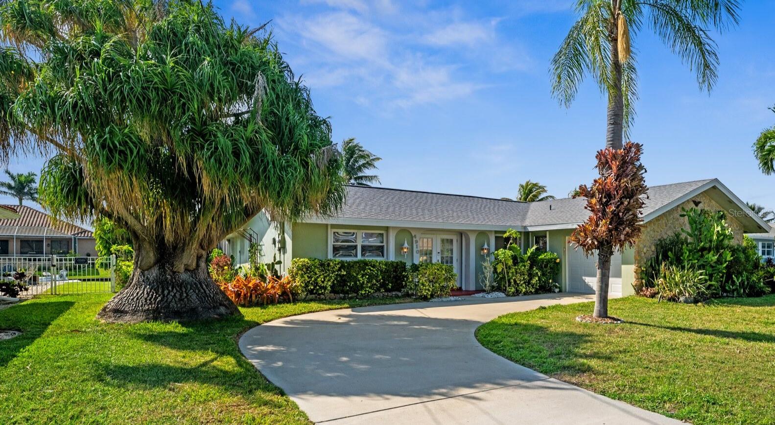 DIRECT GULF ACCESS WESTERN EXPOSURE RETREAT! Welcome to 4910 Sorrento Court, located in one of Cape Coral’s most desirable boating neighborhoods. This 3-bedroom, 2-bath home combines classic Florida charm with modern updates and an unbeatable location just minutes to open water. Enjoy DIRECT SAILBOAT ACCESS with no bridges, a 10,000 lb boat lift, and an 80-foot seawall that makes this a dream for boaters. Inside, the home feels bright and welcoming with a freshly updated kitchen featuring white cabinetry, gold hardware, granite countertops, and stainless steel appliances. A spacious dining area and open living room create great flow for entertaining, while four sets of sliding glass doors lead to the pool area. The enclosed lanai offers its own A/C unit for year-round comfort and overlooks the heated pool surrounded by an expansive paver patio. Recent improvements include a new roof (2024), HVAC system (2023), hurricane shades and shutters, and fresh paint inside. The tropical landscaping adds curb appeal to the quiet, established cul-de-sac. Located just minutes from Downtown Cape Coral and the exciting new Bimini Square waterfront development, this property offers easy access by boat or car to restaurants, beaches, and the Gulf. Whether you’re looking for a full-time home, vacation getaway, or investment property, this one delivers the Southwest Florida lifestyle you’ve been searching for.