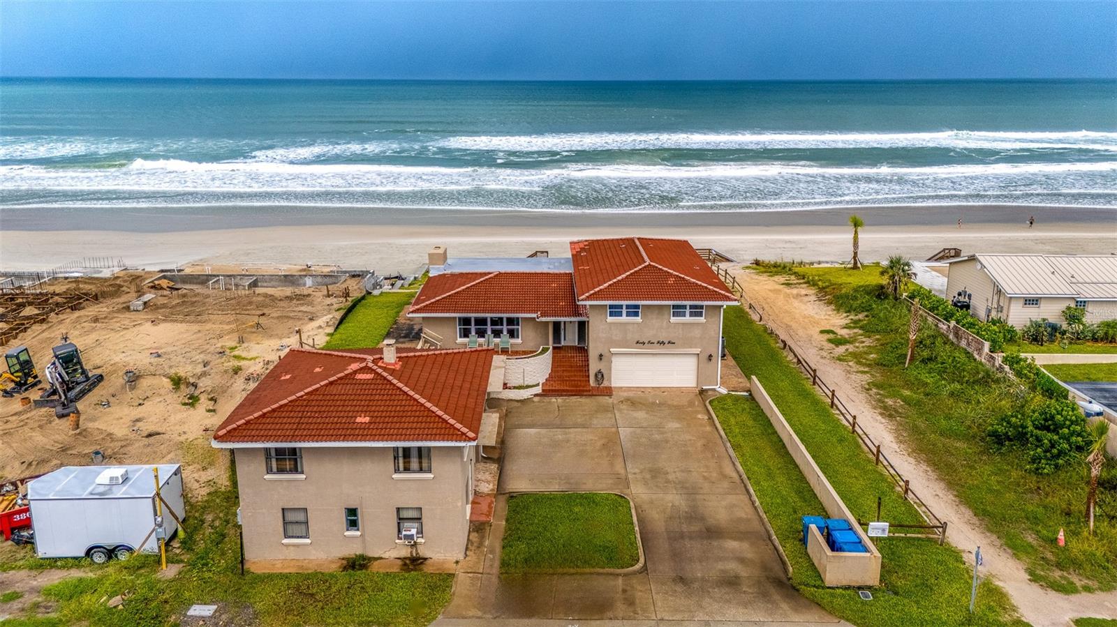 THIS SUBJECT HAS A NEWLY CONSTRUCTED SEAWALL AND BULKHEAD ($562,000 COST) THAT WAS COMPLETED IN EARLY OCTOBER AND HURRICANE TESTED BY "MILTON" THE SAME MONTH. THE HOME CONSISTS OF ~4,236 SF UNDER ROOF WITH 6 BEDROOMS/5 BATHROOMS AND THREE SEPARATE GARAGES FOR 5 VEHICLES. THE MAIN HOME HAD SUSTAINED ROOF DAMAGE FROM HURRICANE MILTON, WHICH IS NOW REPAIRED AND REPLACED BACK TO A “COMPLETED STATE” & CO'D WITH NEWLY CONCRETE REINFORCED LINTELS, ALL NEW TRUSSES IN PLACE AND NEW SIMPSON TIE STRAPS INSTALLED BY VOLUSIA COUNTY CODE STANDARDS. THE PROPERTY ALSO ENCOMPASSES TWO RENTAL UNITS ON SITE (2BED/1BATH & 1BED/1BATH UNITS) THAT BRING GOOD INCOME AT $2,800.00/MONTH (12 MONTH LEASES) OR CAN OTHERWISE BE UTILIZED AS AN "IN-LAW APARTMENT" AND/OR "A STUDIO HOME OFFICE SPACE". THE SUBJECT IMPROVEMENTS ARE ALL SITUATED ON A .37 ACRE SITE NEXT TO THE COUNTY'S BEACH WALK ACCESS DIRECTLY ACROSS FROM CURLEW STREET…