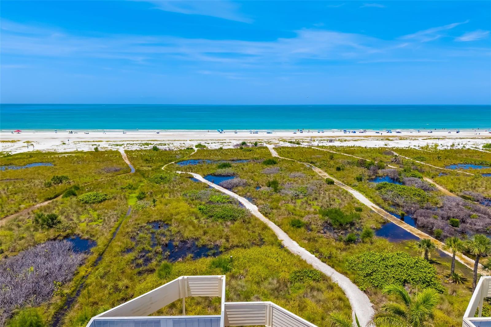 Gulf-front luxury townhome with private beach access on Siesta Key! Soak in the breathtaking, unobstructed views of the Gulf and iconic Siesta Beach from every level of this three-story, turnkey-furnished townhouse-style condominium. Just a short distance from the sand in the intimate, nine-residence enclave of Tiffany Sands, this rare Siesta Key offers blends relaxed beachside living with elegant design and modern comforts. Spanning 2,611 square feet, this three-bedroom, 3.5-bath residence welcomes you with an open-concept main floor that seamlessly connects the kitchen, dining and living areas—all framed by floor-to-ceiling impact-rated sliding glass doors and panoramic Gulf vistas. The living room is anchored by a cozy wood-burning fireplace and enhanced by crown molding, recessed lighting and sleek ceramic tile flooring. Go onto the expansive Gulf-front balcony, an ideal setting for alfresco dining or sunset lounging. The kitchen is stylish and functional, featuring solid-surface countertops, stainless steel appliances, modern cabinetry with pullout shelving, under-cabinet lighting and a breakfast bar for casual meals. Upstairs, the spacious Gulf-front primary suite offers postcard-worthy views, a private balcony, sitting area, double closets and a luxurious en-suite bath with jetted soaking tub, double vanity, separate shower, bidet and two skylights. Two additional guest bedrooms—flexibly configured with a retractable dividing wall—are also on the third floor along with a full guest bath and a well-equipped laundry room. The oversized ground-floor bonus room opens via sliding glass doors to a covered patio just steps from your private beach path. A full bath with walk-in shower was stylishly updated in 2024, making this level ideal for guests, a home gym or media lounge. Additional highlights include a one-car attached garage with extra storage, newer water heater (2024), HVAC (2022), roof and skylights (2017), hurricane shutters and flexibility of 30-day minimum rentals. Just .4 miles from Siesta Village’s vibrant shops and dining, and Siesta Beach Park, this exceptional home delivers the ultimate island lifestyle—whether you’re seeking a serene personal retreat, a seasonal escape or a savvy investment property.