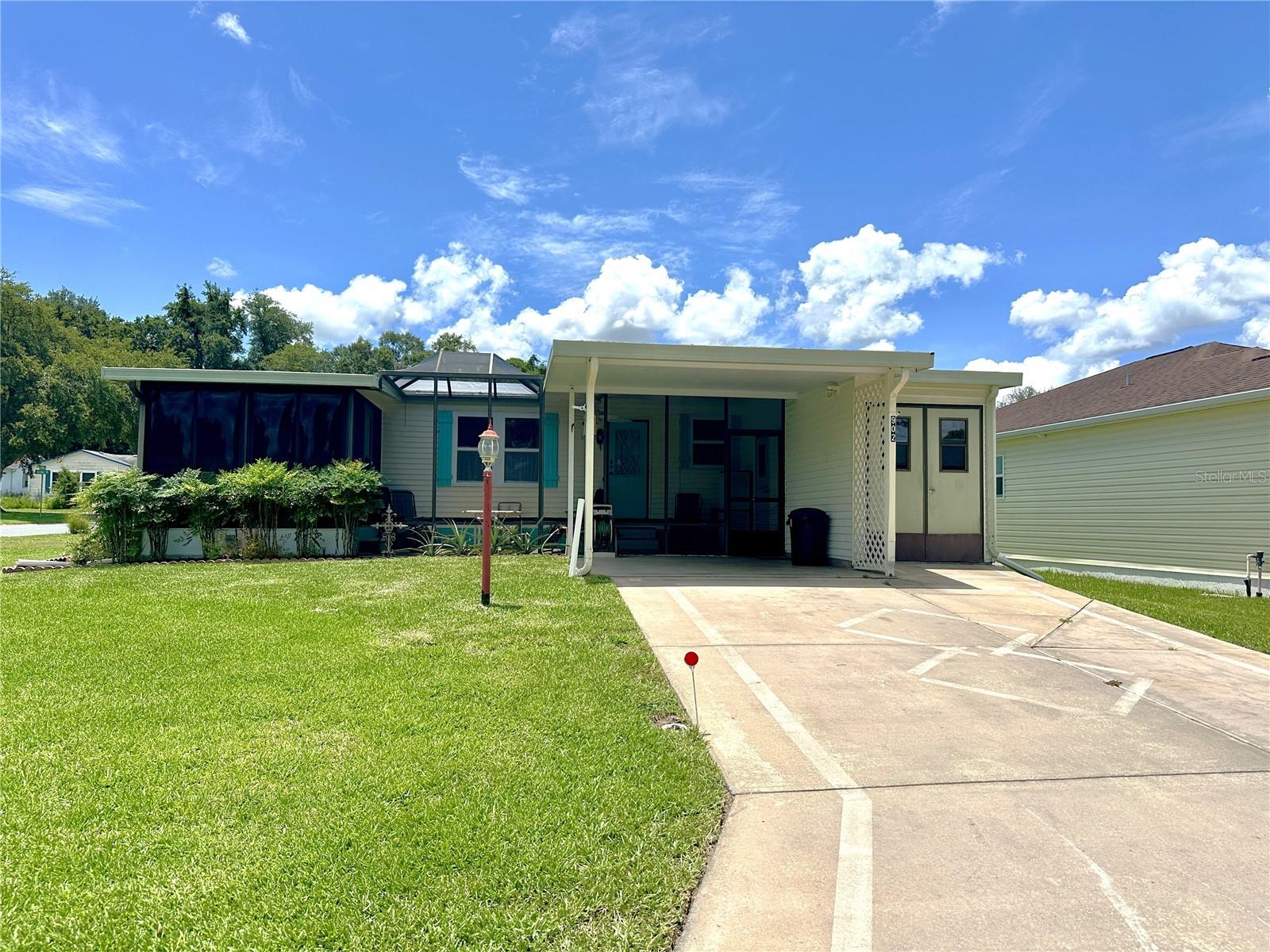 Welcome home to this charming furnished/turnkey 1098sq/ft 2-bedroom 1.5 bath home on a desirable corner lot in The Villages Historic District. This home has just the right amount of room for easy living and entertaining, while remaining low-maintenance and affordable. The exterior of the home is equipped with a golf cart garage, laundry room and oversized outdoor screened porch/patio. Upon entering the home, you will be greeted by a bright and inviting open floor plan that connects the living, dining, and kitchen areas, creating a spacious and functional layout. The kitchen comes complete with everything needed and plenty of cabinet space for both kitchen amenities and food storage. Both bedrooms have ample space and storage, with the guest room features a convenient half-bath and large closet. The full bathroom is thoughtfully designed for daily use and equipped with dual access from the main room and master bedroom. Outside, the corner lot features added outdoor space, perfect for gardening, relaxing, or enjoying the beautiful Florida weather. The front screened porch has ample room to enjoy the bug-free quiet cooler evenings with more than enough room for entertaining neighbors, friends, and family. The property’s location provides easy access Spanish Springs Town Square and the many amenities The Villages has, including golf courses, shopping, dining, recreational opportunities, and Dr offices. This delightful home is an affordable and low cost opportunity to live in The Villages while enjoying added privacy and charm with its corner lot. Make this beautiful home yours today!