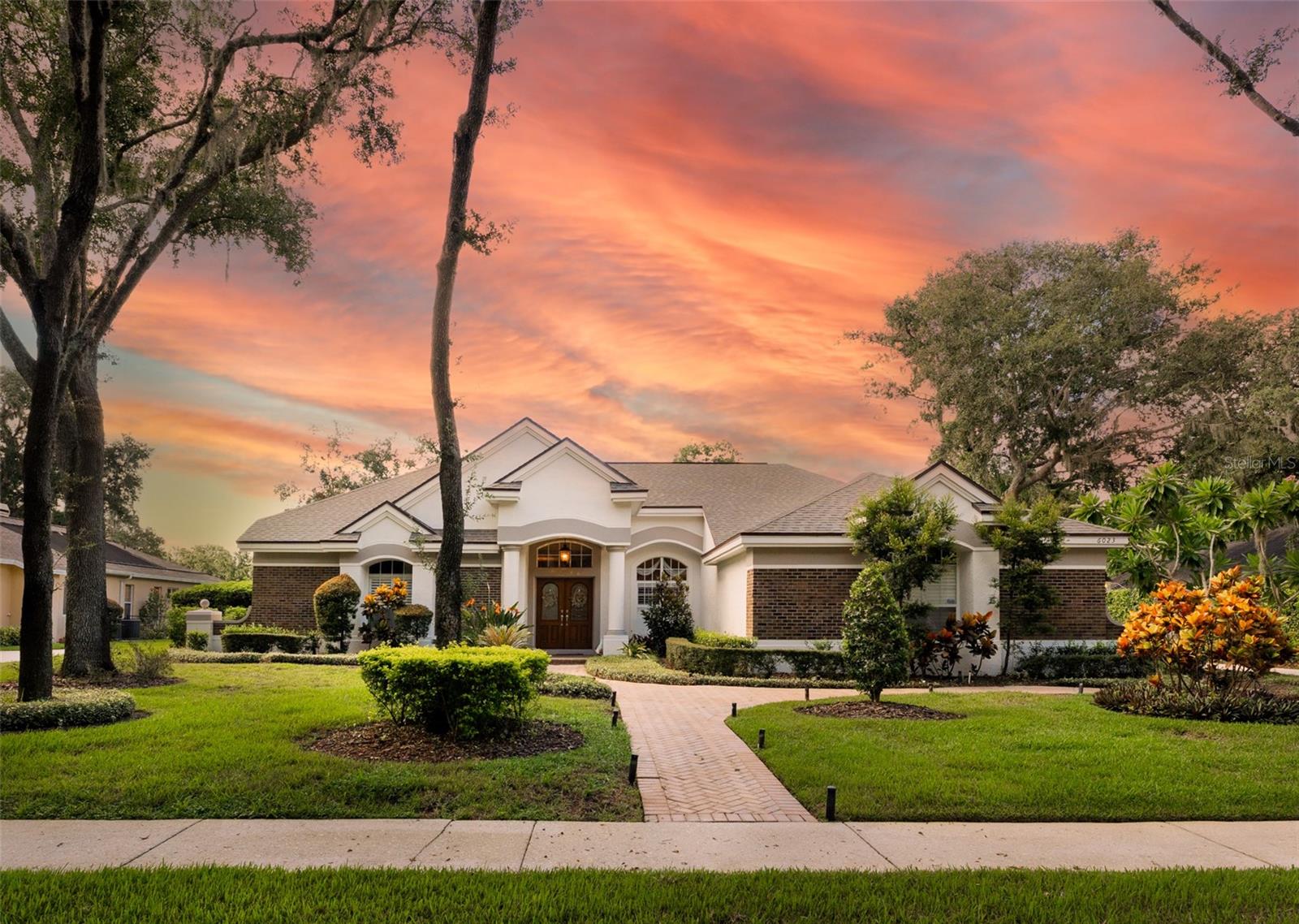 When Only The Best Will Do!! Beautiful homes like this do not come along very often so don't miss this one!! This Arthur Rutenberg home is pristine & has been meticulously cared for from top to bottom. Located in the highly sought after community of Fish Hawk Trails with large executive homesites, miles of trails, wide streets, tennis, basketball, pickleball courts & community center all surrounded by nature & zoned for great schools. Situated on a private half acre fenced lot that backs to conservation green space & located on a double cul-de-sac street with very little traffic. You will be impressed the moment you arrive & notice the lush landscaping, Newer roof, pavered front entry & walkways flanked by elegant landscape lighting. Step through the front doors onto beautiful hardwood and travertine flooring that flows throughout the home. (carpet in the master and bonus room only). The living room was updated with a gorgeous electric fireplace with a custom accent wall of travertine including built in cabinets & shelving. The kitchen is the heart of the home with abundant quality wood cabinetry, gorgeous stone counter tops, custom island with beautiful pendant lighting, lovely tile backsplash, Bosch SS appliances including induction cooktop with SS hood, wall & microwave ovens, dishwasher, refrigerator & wine fridge and is adjacent to the family room with built in wood cabinetry & triple pocket sliders that open up completely to the outdoor space. The primary suite features a spacious bedroom with slider access to the stunning outdoor living space, Ensuite bath with Jetted Soaking tub, dual vanites and a super sized walk in closet with organizers. All main living areas center around the resurfaced sparkling pool/spa with New tile & outdoor living space with wood plank tongue and grove ceiling, pavers & privacy landscaping. The well designed functional floor plan features a three way split with the spacious primary suite privately located on one side of the home. Two of the bedrooms & second bath are located off the kitchen. The 4th bedroom is located at the back of the home adjacent to the bonus room & 3rd bath/pool bath that can be closed off for additional privacy. Great for a guest suite or in-law suite. All bathrooms have been tastefully updated. Other notable features include: Plantation Shutters, Custom Shades & Beautiful Custom Draperies with insulated backing, wood accent trim around all windows, custom cabinetry in the bonus room & family room, updated lighting fixtures & ceiling fans, crown molding throughout, built in organizers in all walk in closets, well for irrigation saving you $$ on your water bill & a water softener. The laundry room has a built in utility sink, cabinets & a nice stone topped folding shelf. Washer and Dryer convey. The oversized 3 car garage has Brand New built in cabinetry along the entire back wall for additional storage with epoxy flooring. Improvements since purchase in 2023 include freshly painted interior and exterior, new 250 gallon propane tank for the Brand new whole house generator, 2 brand new HVAC's, new electric heater for pool/spa & 2nd bath updated to shower with frameless door & new tile, along with new cabinets in garage There is so much Special in this home, come see for yourself. Schedule your appointment today!!