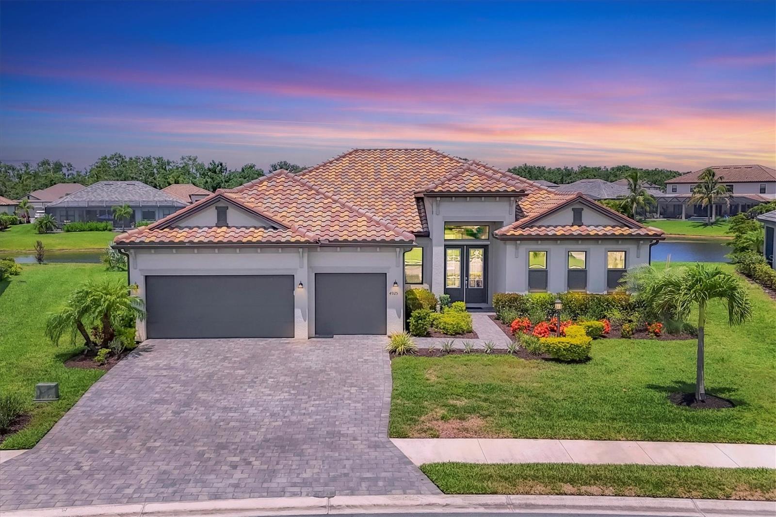 Welcome to your Florida dream home, in Lorraine Lakes at Lakewood Ranch, the #1 planned community in the country! This beautiful lakefront pool home has three bedrooms, three baths, a three-car garage and 2,650 square feet of gracious living space on an oversized lot. Inside, you’ll love the open floor plan with split bedrooms, and spacious kitchen with natural gas, a huge quartz island and seating for all your guests. Stainless steel appliances, walk-in pantry, large farm sink and upgraded lighting throughout. The gathering room opens to your covered and screened lanai with your sparkling heated pool and spa, ideal for relaxing or entertaining. The large sliding glass doors allow easy access for that easy indoor/outdoor lifestyle we crave here in Florida. Enjoy extras like motorized window shades, epoxy-finished garage floors and a gas tankless water heater. The office space can be used as flex space for a multitude of things, including a fourth bedroom. In a gated, maintenance-free community, you'll enjoy resort-style amenities like a clubhouse with dining, fitness center, indoor courts, resort pool, lap pool, splash pad, plus pickleball, tennis, basketball, playgrounds and over 150 miles of trails surrounded by stunning lakes. When you want to venture out on the town, a short drive away are options. Tampa, Sarasota (Siesta Key Beach) and St. Armands Circle for finest dining and shopping. Lakewood Ranch downtown and Waterside are minutes away for shops and dining, live music, polo and international events. This is where you want to live, call today for your personal tour.