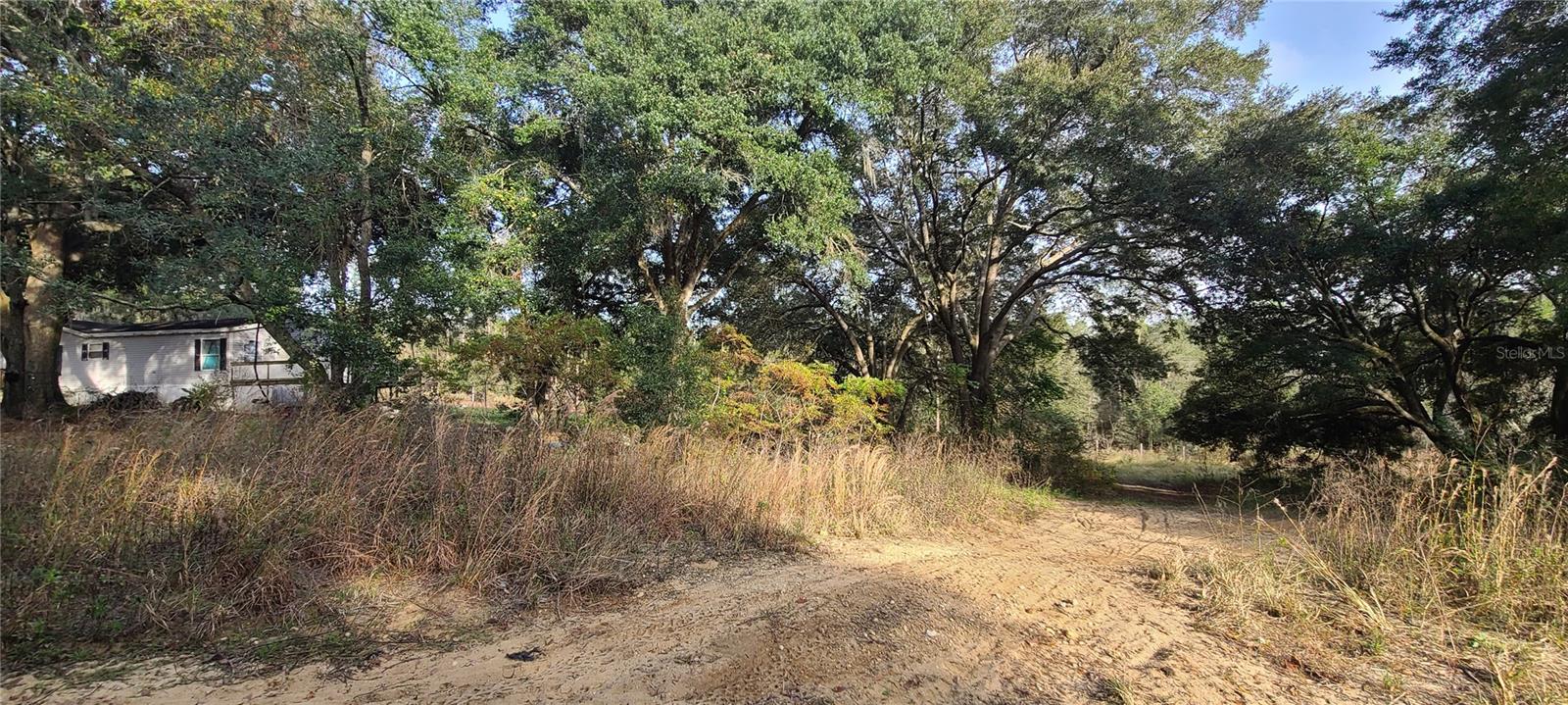 This lot previously had a home on it. Impact fees were paid when previous home was there. Check with county to see if any impact fees are needed for what you are wanting to put on the property. The lot already has a septic please make sure it is in good working condition during your inspection. There is no need for a well because a private water company provides for this community. This lot is not listed that it is in a flood zone but please confirm in your due diligence. This location does not have a homeowners association. So build or set up your manufactured home on this nicely treed lot in a rural location. The Buyers must verify all details of the subject property, and it is recommended to procure their own survey.