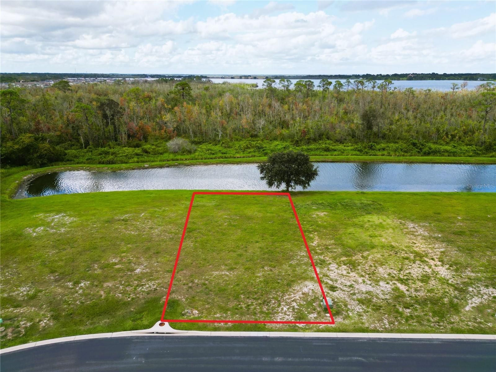 Waterfront Lot in the beautiful, gated community of Water Ridge. Build your custom home on this amply sized lot that offers spectacular views of the fresh water canal and the wooded nature preserve. Water Ridge is a one of a kind, upscale, gated community, situated amongst 3 lovely lakes. The community itself provides great amenities such as multiple tennis and pickleball court complexes, 3 pools, boat ramps, access to all 3 lakes, gym facilities, boat storage, community fishing docks and a beautiful club house. It is conveniently located between Tampa and Orlando off the I-4. Close to Universal Studios, Disney Parks, Adams Estates, Shopping, Restaurants and much more!