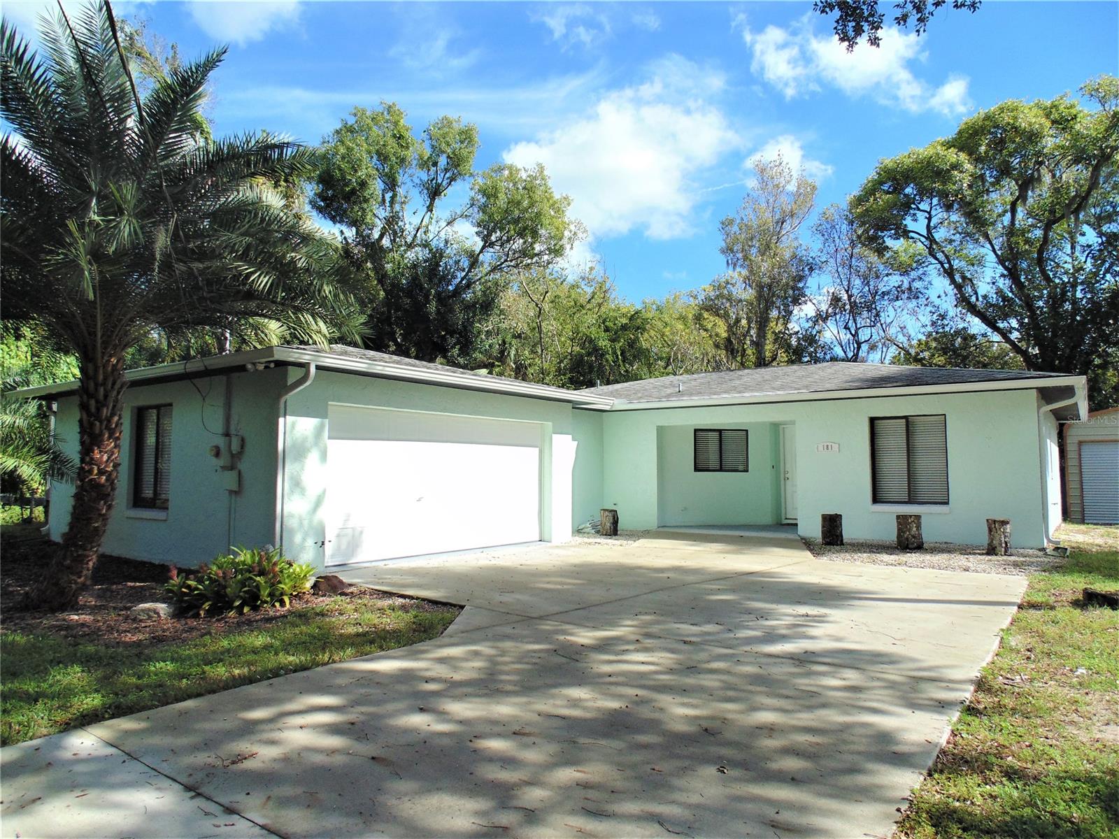 Charming home in the heart of New Smyrna Beach! Home is situated on a 150x117 lot with a BRAND NEW 20x24 metal garage with electricity as well as an attached 2 car garage. New concrete driveway and new crushed asphalt driveway leading to detached garage. Home has an open living and kitchen area with unique architectural features. Living room has laminate wood floors and sliding glass doors that lead to 12x37 covered patio, great for entertaining or relaxing on cool evenings. Patio possibly could be enclosed for added living space. Kitchen has breakfast bar, new garbage disposal with stainless steel armoire style refrigerator, microwave and stove. Large master bedroom and guest bedrooms have laminate wood floors. Master bathroom has been completely remodeled with all new vanity, tile standing shower with glass door, toilet, medicine cabinet and lighting. New HVAC system, new gutters and extensive tree trimming done as well! ;Water: City
