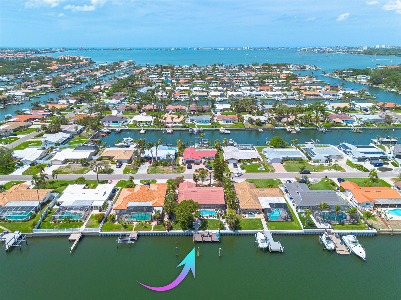 MINIMUM 6 MONTH LEASE ~ FULLY FURNISHED WATERFRONT POOL HOME! Welcome to waterfront living at its finest in Broadwater - St Pete’s highest elevated waterfront community! NO FLOODING - NO DAMAGE from the 2024 hurricane season! This beautifully maintained 3 bedroom, 2 bath home sits on coveted sailboat water with DIRECT, no-fixed bridge access to open waterways! Boca Ciega Bay is less than 1 mile away and the Gulf of Mexico is about 3 miles away. Looking for BOAT STORAGE? Your grandfathered 30 FOOT DOCK can easily accommodate motor or sail boats up to 55 feet and has a 50 amp electrical service and water at the dock. With Eastern exposure, your dock is a delightful place to watch sunrise or enjoy entertainment from the plentiful sea creatures who hunt and play in the canal. Unique qualities abound here with decorative tile accents in the flooring, stained glass French doors, an adobe-style range exhaust, a statement-making arched double doorway and the way this modern home is nestled harmonically among lush Florida-native landscaping, creating a private oasis within a thriving neighborhood. ~ Step inside and enjoy a sightline through to your waterfront sanctuary. The heart of the home is the great room space, combining dining, living and the kitchen and a wall of windows and sliders, allowing the outside in. The vaulted ceiling in the great room provides a grand space with the expansive kitchen anchoring the room. The adobe-style range exhaust creates character over your natural gas cooktop. Abundant deep cabinets and tons of counter space make this a chef’s dream and provides plenty of room for collaboration at dinner time. This home offers a split floor plan and the spacious owner’s suite includes pool views, a large walk-in closet and laundry closet, as well as a roomy ensuite bath featuring separate vanities, a garden tub, tiled shower and even a bidet. Two guest rooms are found opposite the owner’s suite and they share a full guest bath with a tub and a private slider outside, serving well as a pool bath. Bedroom 3 has a bonus space that overlooks the canal and has private access to the pool deck. This space serves well as a home gym, office, or book nook area. ~ Your serene backyard is the ideal spot to wind down after a long day. The vaulted pool enclosure protects your oversized pool deck with tons of lounging space and a separate area for outdoor dining. In 2023, the fiberglass pool was re-gel coated and the pump was replaced and in 2025 the gas heater was replaced. This 10,000 SqFt lot holds this expansive home and pool space and still allows for plenty of yard space for gardening, playing or just relaxing among your tropical flora. ~ Hurricane shutters, a hurricane-rated garage door and 3-nail roof connection qualify for insurance discounts. The tile roof is 2008, the seawall was replaced in 2024, the 20+ seer HVAC was replaced in 2024, and plumbing has been updated. ~ Schedule your showing! (Please note that only half of the garage is accessible to the tenant; the homeowner utilizes the other half.)