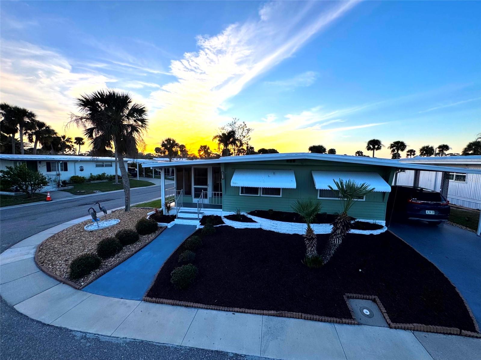 Beautiful double wide unit with many new upgrades! Fully turnkey furnished and ready to move in! This gem is nestled in a spacious corner lot in the desirable Japanese Gardens neighborhood of Venice, FL. 2 bedroom 2 bath with lots of natural sunlight and updated kitchen, baths, and flooring. New roof, air conditioning, and water heater. This home is open concept with the fully refurbished kitchen with dishwasher flowing seamlessly into an expansive Family Room, Dining Area, and heated / AC Florida Room perfect for both relaxation and entertaining. The generous Primary Bedroom includes an en-Suite Bathroom with walk-in shower, two standard closets, a walk-in closet, built-in dresser drawers and private entrance. The Second Bedroom also offers two standard closets and built-in dresser drawers. Additional storage for clothing, pantry or beach accessories available with two hallway closets. Outside, the 2 vehicle carport leads to a separate laundry-utility room with a work sink. The recently refreshed landscaping features a variety of Florida-loving plants, green grass, mulch, and river rock. Located a mere 1.5 miles from secret hideaway Manasota Beach, this property provides access to an oversized Pool, pickleball, shuffleboard, and Bocce Ball courts, a quaint Library, a clubhouse for special occasions, and daily organized activities to meet your neighbors all within the subdivision.