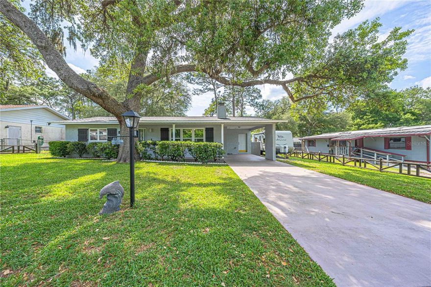 Owner-loved home in desirable Silver Springs Woods — not a flip! This beautifully updated property showcases quality upgrades throughout. The custom kitchen features real wood cabinetry, walnut butcher block countertops, crown molding, designer backsplash, gas stove, dishwasher, large pantry, and broom closet. All appliances stay, including washer, dryer, microwave, stove, refrigerator, and dishwasher. Spacious laundry room offers additional cabinets for storage.
Enjoy the cozy wood-burning fireplace with stunning cedar accent wall and cedar live-edge mantle in the living room. Front windows have been replaced, and both bathrooms have been tastefully remodeled. The primary suite offers two separate his-and-her closets.
Relax year-round in the three-season porch with sliders to the lanai, plus an additional covered patio area. Exterior features include a fully fenced yard, cross fencing with solar lights, irrigation well, front irrigation system, workshop on slab with electric, and 30-amp RV hookup with water connection under the carport.
Major updates include a 2025 roof, two new mini-split systems, and wind mitigation report for lower insurance costs. Average electric bill is approximately $100/month. Do you love fishing??  Lauch your boat at Mill Dam on Lake Bryant. This special property offers comfort, charm, and exceptional value!