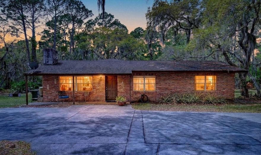 Rare opportunity property in Port Orange with land, space, and development potential. This 5 bedroom, 3 bathroom home sits on 1.65 acres and offers a rare combination of privacy and versatility. The layout works well for multigenerational living with plenty of room for extended family, guests, or even potential rental use. The home does need some updates and TLC, giving the next owner a chance to improve it and build equity. The fully fenced 1.65 acre lot is filled with mature oak trees that provide shade and a quiet, private setting. There is plenty of open space to enjoy the outdoors while still being close to everyday conveniences. The property includes a large detached garage building with room for vehicles, boats, RVs, or workspace, along with a separate shed that can be used as a workshop, hobby area, or additional storage. There may be potential to subdivide into up to three lots to build additional homes on, buyer to verify with the county, which adds to the overall value and flexibility of the property. Properties with this much land and potential in Port Orange are not easy to find. This is a great opportunity for someone looking for space and future upside.