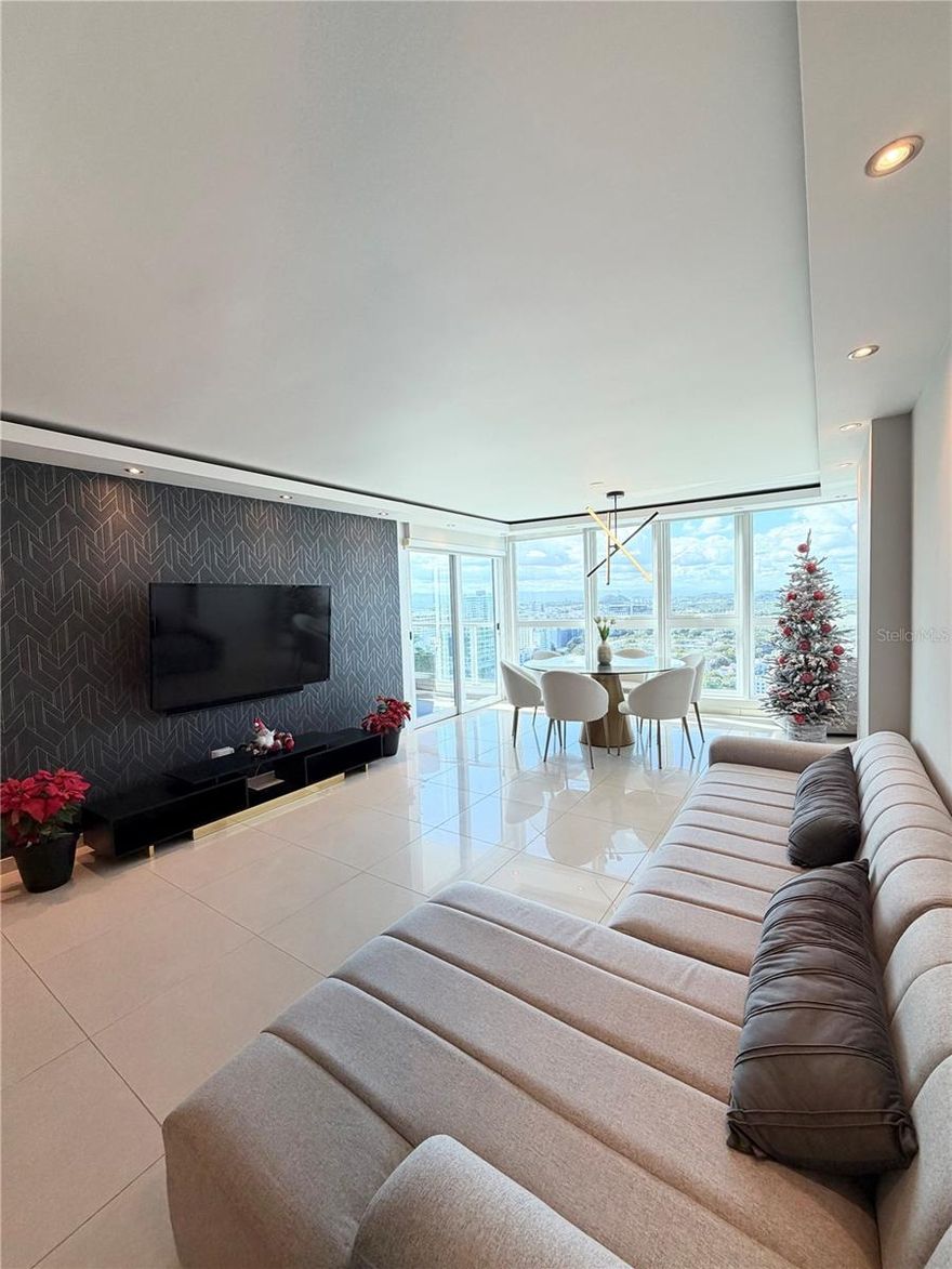 Discover luxury living at its finest in Hato Rey with this stunning 2-bedroom, 2-bathroom apartment in Cond. Aquablue building. Situated on the 26th floor, this exquisite unit offers breathtaking panoramic views of Old San Juan, the bay, and Hato Rey city. The apartment features a master suite with a walk-in closet, a gourmet kitchen equipped with top-of-the-line appliances including a wine bar and dishwasher, a balcony, and air conditioning throughout. The apartment comes fully furnished, offering a move-in ready experience. The building boasts an array of amenities such as a full power generator, two convenient elevators, a gym, a 24/7 security guard, concierge service, a sparkling pool, ample visitor parking, and two indoor parking spaces. Nestled in a prime location with easy access to local amenities and attractions, this luxurious apartment provides the perfect blend of comfort and style. Don't miss the opportunity to make this exquisite residence your home. Contact us for more details.