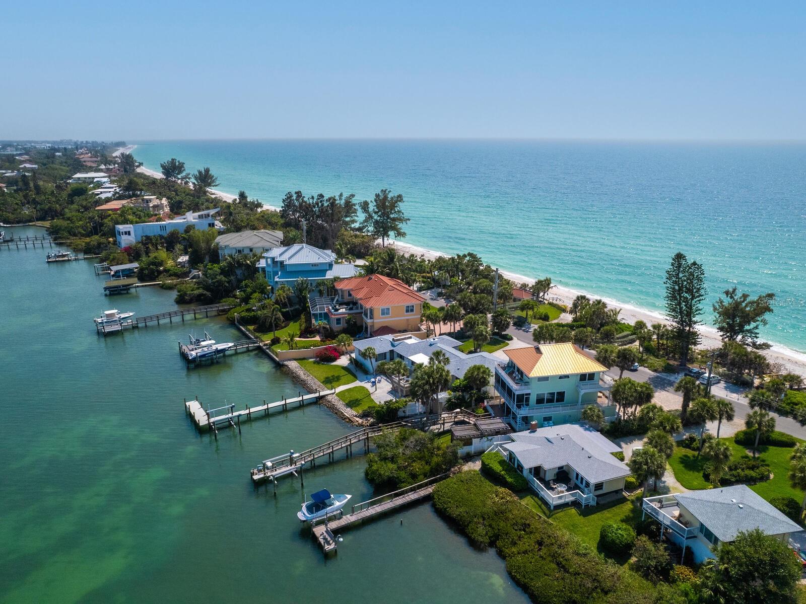 Casey Key on your list of places to live? Imagine waking up to the sun rising over the bay and stepping out onto your own private sandy beach. The incomparable views of the Intracoastal Waterway and the Gulf of Mexico are breathtaking. This Gulf-to-bay property offers the best of waterfront living on Casey Key's natural eight-mile barrier island. The vintage cottage has been impeccably maintained and is move-in ready, featuring a spacious living room, two bedrooms, an office/possible third bedroom, and a dining area overlooking Blackburn Bay. Outside, a quiet deck and dock with a 10,000-pound boat lift installed in 2021 provide some of the deepest boating water in the area for all your water adventures. With a new roof in 2023, fresh paint, and enhanced landscaping, there's so much to love. Whether you're enjoying the home or considering building a new one, we can assist with a carefully curated list of architects and builders. Casey Key, with private air travel just 15 minutes away at the Venice airport and 30 minutes to Sarasota International, caters to every imaginable lifestyle, offering nearby shopping, dining, golf, and more. This charming beach house and slice of paradise could finally be yours!