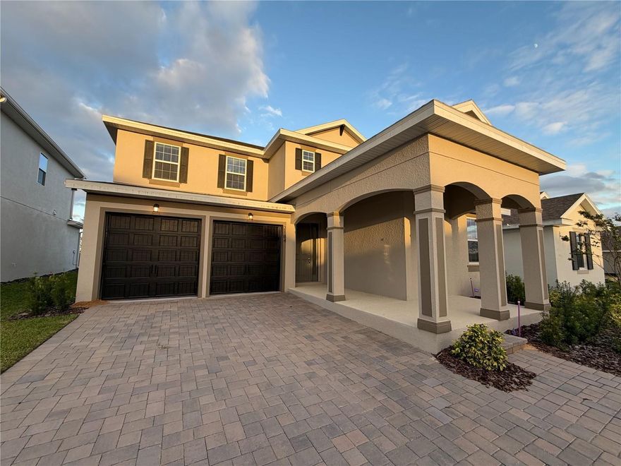 We are pleased to present this stunning newly built residence (2025), located in the desirable Hills of Minneola community. This home has never been occupied and is being offered for rent for the very first time, providing a truly brand-new living experience. This two-story home combines contemporary elegance, comfort, and functionality, offering an impeccable environment for those seeking to live with style and quality.
Upon entering, you are welcomed by a grand foyer with soaring double-height ceilings, creating an immediate sense of openness and sophistication. The staircase and upstairs overlook, featuring wood railings and black iron balusters, form one of the home’s most striking architectural elements, adding character and presence from the moment you arrive.
The social area has been designed to maximize natural light and connection between spaces. The bright kitchen, with soft-tone wood cabinetry and quartz countertops, flows seamlessly into the adjoining living spaces, creating the perfect setting for hosting and everyday living. As an added convenience, all appliances are brand-new — including refrigerator, range with oven, microwave, dishwasher, and washer-dryer set — providing both practicality and a refined touch to your daily routine.
The home features four bedrooms, including a truly impressive primary suite that provides an atmosphere of refinement and relaxation. The primary bathroom showcases exquisite finishes, with quartz countertops and a stylish integrated vanity area. Upstairs, an additional suite offers extra privacy for guests, family members, or flexible use. Another highlight is the expansive bonus room, beautifully illuminated and featuring a floor outlet — ideal for a home theater, second living room, creative studio, or entertainment space.
A dedicated office offers the perfect setting for those who work from home. Outside, the covered lanai and flat, landscaped backyard create a peaceful setting, with an open view of the green horizon and sky — a serene backdrop for moments of rest and contemplation. The home also includes exterior outlets pre-wired for cameras or festive lighting, enhancing convenience and flexibility.
This residence features premium finishes and a contemporary, welcoming atmosphere, thoughtfully designed to offer absolute comfort and everyday practicality. A perfect balance of sophistication and well-being, this home provides a serene and inspiring environment, ready to welcome its new residents with exceptional charm and quality.