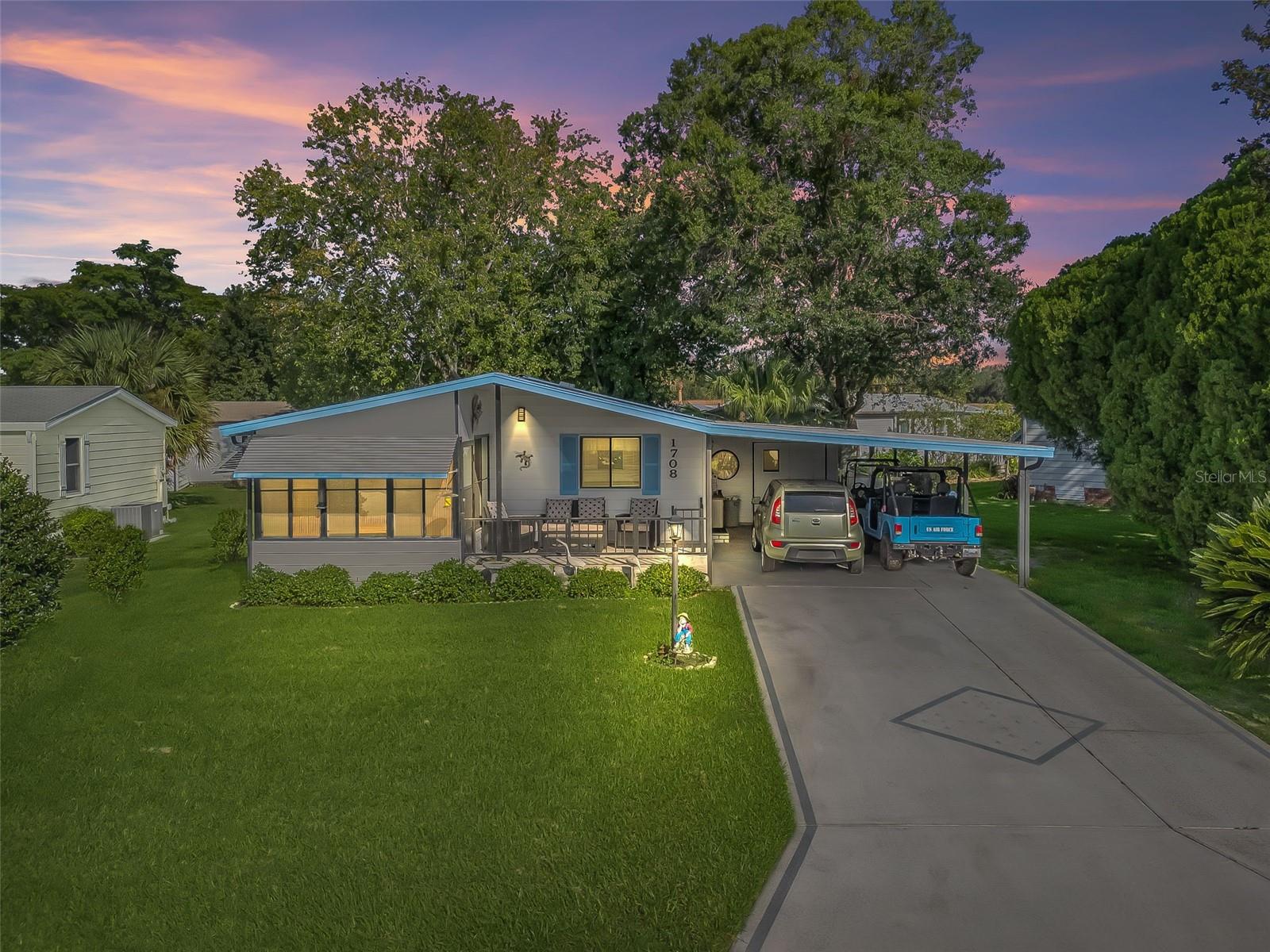 Welcome to this super cute, nicely updated and fully furnished home located in the Historic Side of The Villages. From the moment you step inside, you’ll appreciate the freshly painted interior, luxury vinyl plank flooring throughout, and thoughtful upgrades that make this home truly move-in ready. The kitchen has new wooden cabinets with dovetail drawers, a convenient lazy Susan, granite countertops, a stylish tile backsplash, stainless steel appliances, and a modern stainless steel sink complete with drying racks and a cutting board. Both bathrooms have been tastefully updated with new vanities and sinks, and the home includes a spacious Florida room, ideal for relaxing or entertaining guests. The primary bedroom has a built-in feature wall with an electric fireplace and wall-mounted TV, creating a cozy retreat. Outside, the large carport provides plenty of space for multiple vehicles and includes an inside golf cart garage for added convenience. The laundry area is located in the attached utility room off the carport. This home is the perfect blend of comfort, style, and functionality—schedule your private showing today and see for yourself!