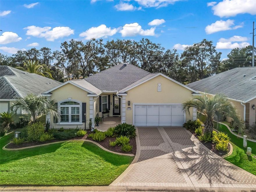 Stonecrest is a 55+ gated golf course community with all the amenities and 4 pools (one indoor), and just a Bridge Away By Golf Cart To The Villages!  Charming 3/2 Chestnut with a 2 Car Garage + Workshop, ROOF 2022, No Rear Neighbors, offers Tremendous curb appeal featuring Designer Paver Driveway & Walkway, Lush Professional Tropical Landscaping, and a Covered Front Entrance with a Gorgeous Leaded Glass Door.  You will Love this Open Concept and Split Floor Plan, providing plenty of Space, and Natural Light, making the Chestnut model just perfect for Entertaining Friends and Family! This well appointed home boasts Plantation Shutters, Upgraded Light Fixtures, Glowing Laminate Flooring, Wainscoting, High Ceilings, French Doors, and a Covered Lanai with a Birdcage attachment.  The Large Eat in Kitchen showcases Stainless Appliances, Double Oven, White Wood Cabinetry, Large Pantry Closet, Center Island with Additional Storage, and Seating, and Access to the Covered Lanai. The thoughtfully designed Split Floor Plan offers Privacy for both the Owners and their Guest, with the Primary Suite secluded on one side of the home for an Ultimate Private Retreat, while the Secondary bedrooms, and Guest bathroom are nestled on the opposite side of the home.  The Lovely Primary Suite boasts a luxurious En Suite bathroom showcasing a Private Water Closet, Walk in Shower, a Two Sink Vanity, and a Large Walk in Closet.  Bedroom Two features a nice size built in closet, and a Built in Murphy Bed, while bedroom three (no closet) can be used as an office or den.  The Guest bathroom provides a nice size vanity with a decorative Vessel Sink, and a tub and shower combination, offering your guests plenty of privacy, and convenience.  Enjoy the warm climate Florida has to offer while protected from the sun on the Covered Lanai, with Birdcage attachment providing multiple seating areas, and blending outdoor relaxation with indoor comfort, making it a perfect setting for enjoying dining, entertaining, and enjoying nature.  There is plenty of room for all your storage needs in the 2 Car Garage, with 7x10 Workshop!  Stonecrest is a 55+ gated golf course community with all the amenities, pools, pickleball courts, softball, 18 hole championship golf course, Broad Stripes Golf & Social Club and over 80 different clubs to join! As a private gated golf course community, you can expect a high level of privacy and security. Overall, this home offers a combination of Exceptional Floor Plan, Luxurious Features, a Fantastic Location with No Rear Neighbors, and a Secure Community Setting. A WONDERFUL LIFESTYLE AWAITS YOU IN STONECREST!