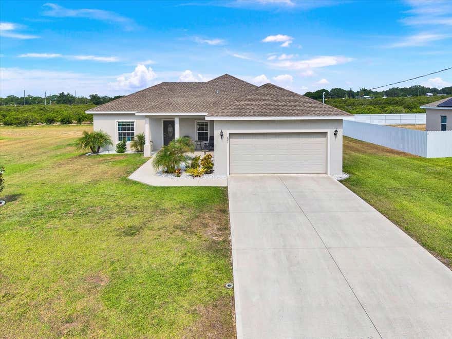 Built in 2023, this well-maintained home offers a modern layout and a convenient location across the street from Lake Lotela. The property provides easy access to nearby outdoor recreation and scenic surroundings.

Inside, the home features an open floor plan designed for comfortable everyday living and entertaining. Newer construction provides updated systems, energy efficiency, and contemporary finishes.

The backyard backs up to an orange grove with no rear neighbors, offering added privacy and a peaceful setting. Located outside of a designated flood zone. No lease restrictions are currently in place, providing flexibility for future use.

Conveniently located near shopping, dining, and other local amenities.