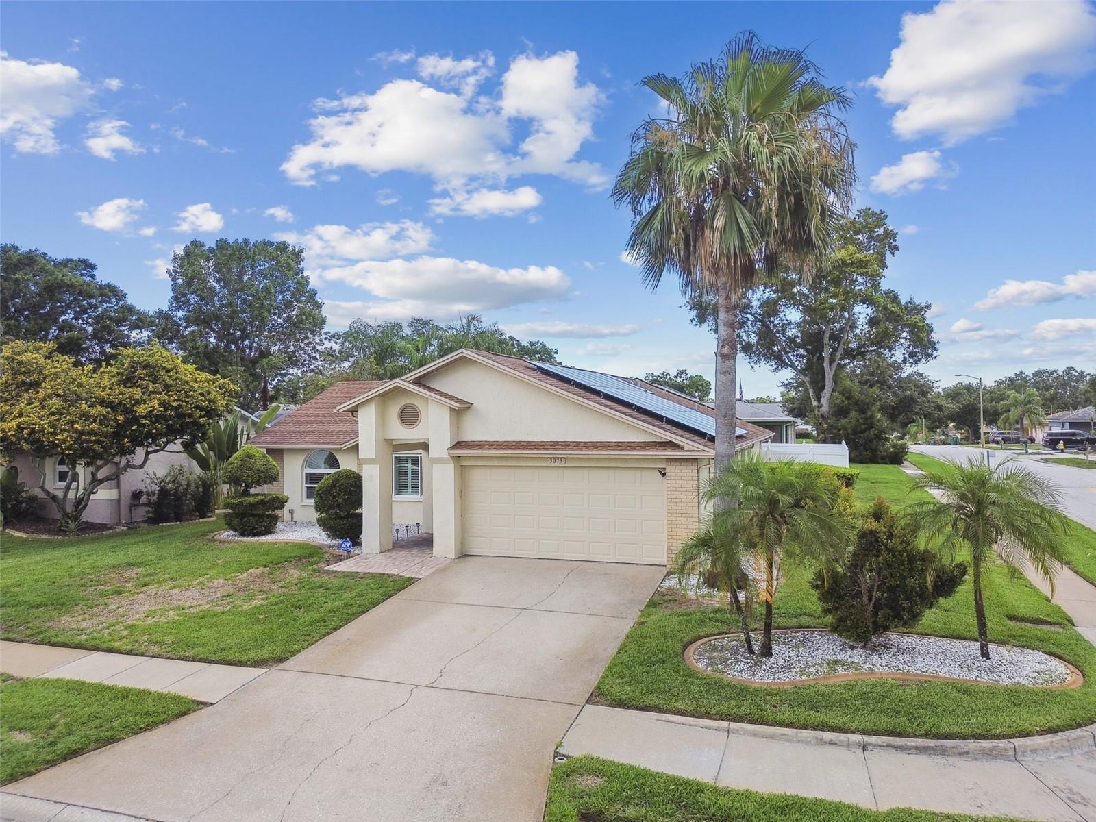 Welcome to this home in the much sought after Alderman Ridge Community in Palm Harbor. SAVE on your electric bill with Solar Energy panels that are paid for. Move in ready 3BR/2BTH Pool home featuring open floor plan that is perfect for entertaining family and friends. Large Lanai features brick pavers with a sparkling Pebble Tech Pool and ample yard for your outdoor enjoyment. Updated gourmet kitchen with stainless appliances and granite countertops for the discerning chef! Bonus room with closet and air conditioning has been added to a portion of the garage area, that can be converted back. New garage door and opener have been installed recently. The vinyl fence offers complete privacy on this beautifully situated corner lot. Great school system and convenient to main highways and shopping.