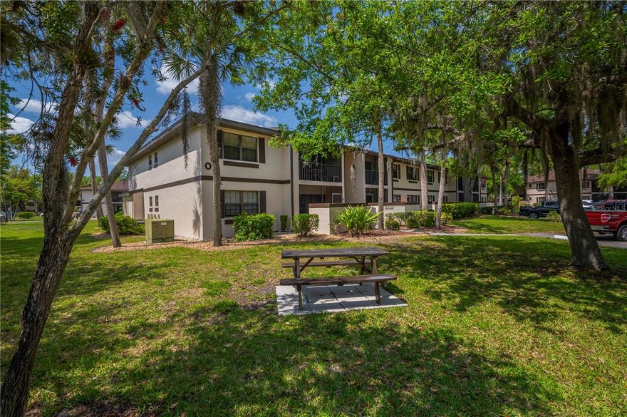 Welcome to Oaks III! Located in the heart of Port Charlotte-this community was built around the native oak trees which makes you feel like you are in the country-yet conveniently located with only a short walk to shopping (Publix, Mini Walmart, Lowes, Home Goods, Kohls & many more) & restaurants! This 2nd floor condo is a corner unit & is super clean, comes turnkey furnished & ready to move right in. This one bedroom, one bath unit is in a prime location with only a short walk to the community clubhouse/pool. Features include screen door for ventilation, tile floors in foyer, kitchen, bath, & lanai,  carpet in master bedroom, living/dining room, good sized living room w/ceiling fan  and a bay of 3 sliders out to the screened lanai, dining area adjoins the living room, niche in dining area has a cabinet & shelving for storage, kitchen opens up to the living/dining area, & has a breakfast bar, & is equipped with all the appliances, interior laundry closet w/stack washer & dryer, roomy master bedroom w/full wall closet, ceiling fan & pocket door to the ensuite master bath, master bath has tub/shower, & linen closet. Low fees of $274 month! New roof in 2023. Amenities inc. a heated pool, clubhouse, shuffleboard & more! This condo. will make a great seasonal home or full-time residence. Shows Great, so make an appointment to see this condo today!