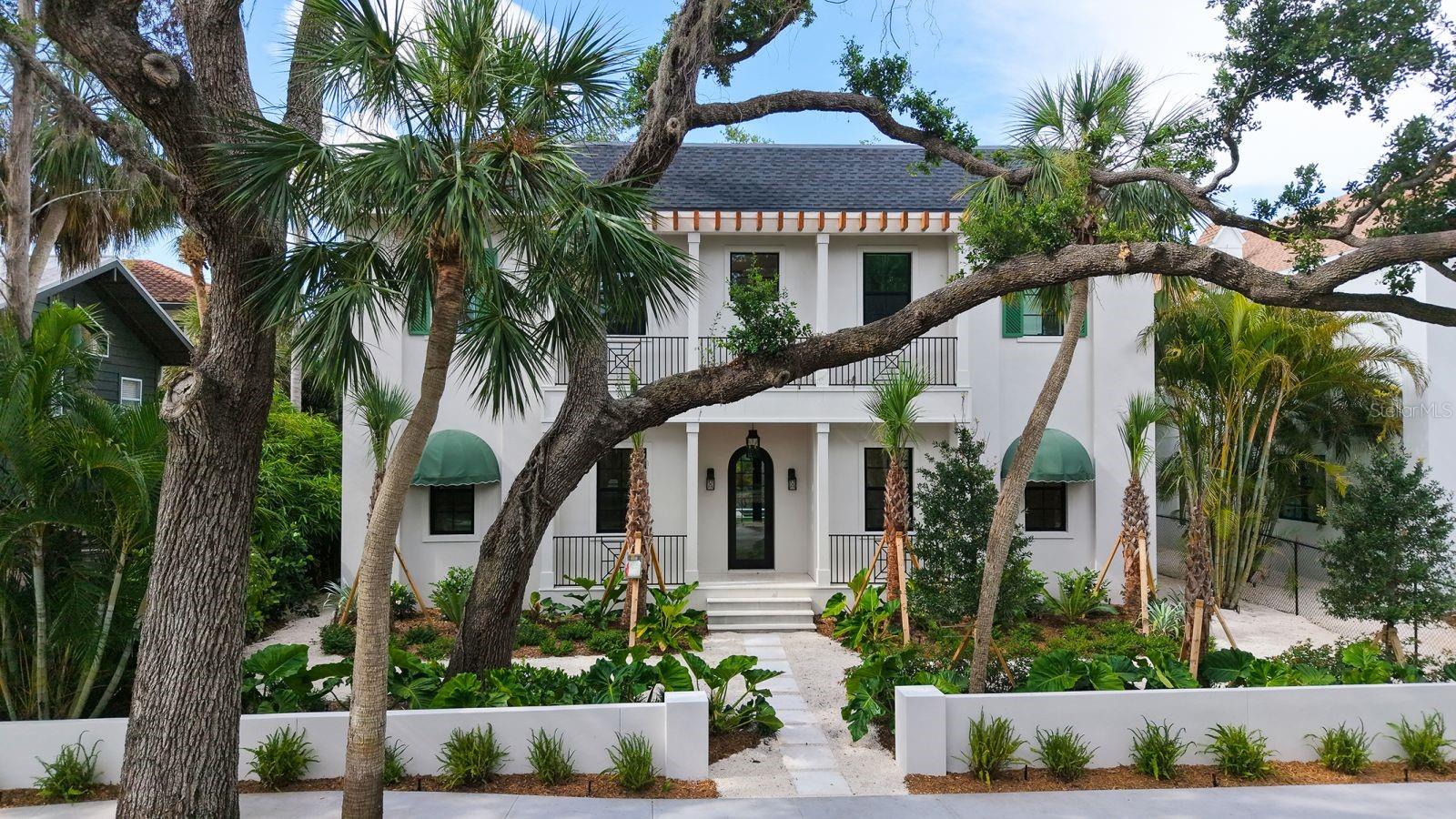 One or more photo(s) has been virtually staged. Drive under the serene canopy of oaks, and you will arrive at 1658 Bonita Lane, a brand-new custom construction, classic Spanish design inspired by the refined and timeless architecture of Palm Beach, Florida. Connected to nature with a quiet elegance, this residence features just under 4,000 square feet of 5 bedrooms, 4.5 baths and lots of versatility with an upstairs bonus room, including a mother in law suite and sitting room- perfect for guests or a home office. Privacy abounds from both the lush landscaping that surrounds the property and its unique position spanning the entire block with a back entry garage off of Bay Road. Soft sunlight cascades in through the two stories of oversized windows over the Great Room that opens both onto the beautifully designed kitchen and to the pool.
The backyard oasis has been thoughtfully designed with a Cypress clad covered patio, Astro turf surrounding the pool to ensure lush greenery year-round, and space for the new owners to design their own outdoor kitchen. Granada Park is a special, tucked away neighborhood, quiet for its residents without a lot of traffic, yet only a few minutes away from our world famous Siesta Key beaches, and downtown Sarasota. Come admire the meticulous details of this home yourself, and then make it yours for your family to enjoy forever. The majestic palms and Giganteum Elephant Ear plants framing this special home are welcoming your arrival!