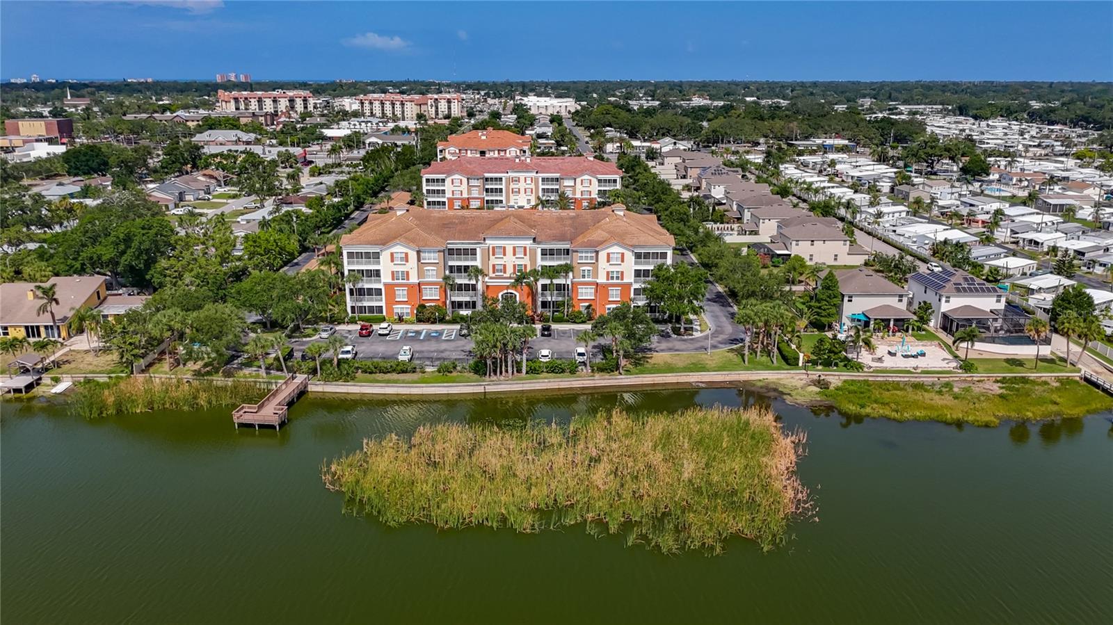 Welcome to Monterey at Lake Seminole, a secure, gated community offering resort-style living just minutes from the Gulf beaches and Seminole City Center. This fully finished 3-bedroom, 2-bathroom ground-floor condo features nearly 1,900 square feet of open-concept living space with 9-foot ceilings and a thoughtfully designed split-bedroom layout that provides both privacy and functionality. The interior boasts a spacious and modern kitchen with abundant cabinetry and solid-surface countertops, perfect for cooking and entertaining. A formal dining room with elegant molding flows into a large, comfortable living area that opens to a screened-in patio with beautiful views of Lake Seminole —ideal for morning coffee or evening relaxation. The primary suite is a true retreat, featuring a massive walk-in closet with a custom built-in closet system and a luxurious en-suite bath complete with a large soaking tub, separate shower stall, dual vanities, and a private toilet closet. The guest bedrooms are generously sized, with one offering direct access to the second full bath, which also includes a guest entry. A separate laundry room includes a washer and dryer for added convenience, and an exterior storage closet off the patio offers additional space for bikes or tools. Residents of Monterey at Lake Seminole enjoy a wide range of amenities, including a heated resort-style pool, a fully equipped fitness center, a fishing dock on Lake Seminole, outdoor grilling areas, scenic walking paths, and a secure lobby with FOB access. The unit includes convenient parking with ample guest spaces. Ideally located on Lake Seminole and less than ten minutes from the Gulf beaches, this condo offers the perfect blend of comfort, convenience, and Florida lifestyle. Schedule your private showing today—this exceptional rental won't last long.