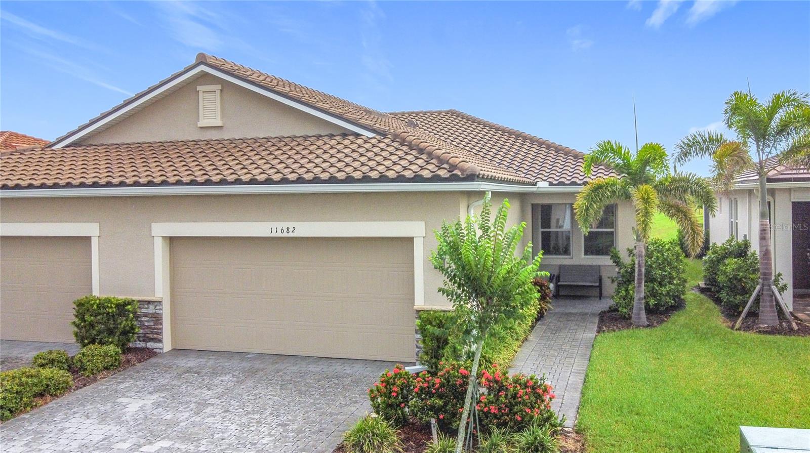 STUNNING LAKE VIEWS, MOMENTS FROM DOWNTOWN WELLEN PARK! FURNISHINGS INCLUDED! Don’t miss your opportunity to own this beautifully appointed Largo model villa in the sought-after, gated community of Renaissance at Wellen Park. Built in 2022, this gently lived-in home still feels brand new — and villas with this premium water view are a rare find in this sought-after community! From the moment you arrive, the decorative paver driveway and walkway set the tone, while the charming front porch offers the perfect spot to relax and unwind. Step through the glass entry door to a welcoming foyer where wood-look plank tile floors, abundant natural light, and a thoughtful open design create an airy, inviting atmosphere. Off the foyer, you'll find a versatile den — ideal as a home office, flex-space, or third bedroom. A private guest suite with a large closet and nearby full bathroom with quartz vanity and shower/tub combo ensures comfort for visitors. At the heart of the home, the open-concept kitchen and living area shine with 42-inch cabinetry, quartz countertops, stainless steel appliances, recessed lighting, and sliding glass pocket door leading to the extended screened lanai. Here, you’ll enjoy sweeping long-lake views framed by tropical landscaping—a peaceful backdrop for morning coffee, entertaining friends, or spotting Florida’s native birds. The primary suite also enjoys the serene lake view and boasts a spa-inspired bath with dual-sink vanity, tiled glass shower, private water closet, and an oversized walk-in closet. Additional highlights include a full two-car garage with epoxy flooring and utility tub, maintenance-assisted exterior (including lawn care), and reasonable HOA fees. Safety minded owners will enjoy the reassurance of hurricane shutters, tile roof, and flood zone X! Life at Renaissance means resort-style living with amenities such as a zero-entry pool with lap lanes, hot tub, fitness center, clubhouse with catering kitchen, outdoor fireplace patio, tennis & pickleball courts, playground, dog park, and more. All this is just minutes from CoolToday Park (spring training home of the Atlanta Braves), Downtown Wellen Park restaurants, shops and events, plus weekly farmer’s markets. With convenient access to both I-75 and Tamiami Trail, you’re a short drive to numerous local beaches, historic Downtown Venice, and booming North Port with Costco and more! This villa offers the perfect combination of modern living, incredible amenities, and an unbeatable location. Schedule your showing today!
