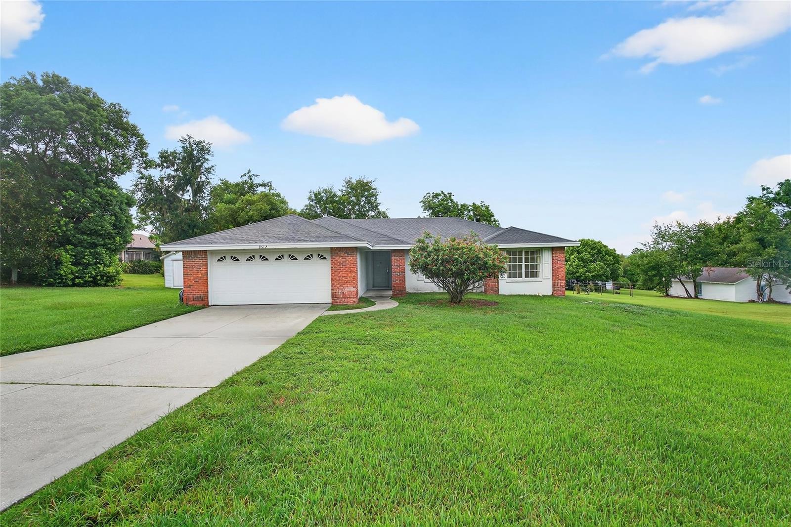 One or more photo(s) has been virtually staged. Welcome to this beautiful and well-maintained 3-bedroom, 2-bath home with a bright Florida room, tucked away on a quiet cul-de-sac in the desirable Lakeland Highlands area! Situated on nearly half an acre with a spacious 2-car garage, this move-in ready property offers an open floor plan with vaulted ceilings, split bedrooms, a dedicated laundry room, and abundant natural light. The kitchen features a pantry, range, refrigerator, dishwasher, and ample counter space, while the primary suite offers a walk-in closet and private bath. The roof is just 3 years old, providing peace of mind and lower long-term maintenance. The expansive backyard offers plenty of room for outdoor activities, and with no HOA, you’ll enjoy added freedom and savings. Plus, this home qualifies for USDA financing! Conveniently located near schools, shopping, dining, and major roadways—don’t miss the opportunity to make this charming property yours!