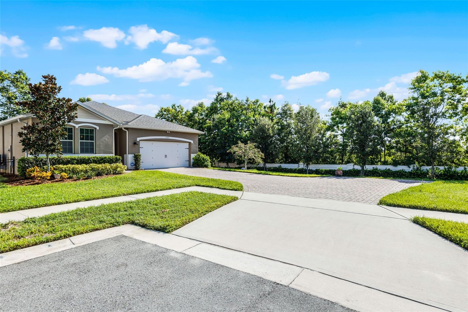 Tucked away at the end of a quiet street in the desirable Rosecrest community, this beautifully maintained 3-bedroom, 2-bath home offers the perfect blend of privacy, space, and style. With no rear neighbors and no right-side neighbors, you’ll enjoy peace and seclusion rarely found in suburban living. From the moment you arrive, the extra-large paver driveway makes a strong impression—providing ample space for multiple vehicles, guests, or recreational use, all while enhancing the home’s curb appeal. Step inside to discover thoughtful upgrades throughout. Just off the entryway, a spacious guest bedroom features upgraded vinyl flooring and a remote-controlled ceiling fan. The third bedroom offers flexibility for your lifestyle—perfect as a home office, man cave, or craft room, and also includes custom lighting and upgraded flooring. Past the office, the spacious living area flows seamlessly into a well-appointed kitchen and dining space—perfect for entertaining or relaxing. You will love the kitchen upgrades that include custom backsplash, new dishwasher and custom lighting. It also has large granite countertop for all your cooking needs along with a spacious walk-in pantry. The dining room, overlooking the backyard and screened patio, also has custom lighting. Past the dining room is the spacious owner's suite complete with upgraded vinyl flooring, tall ceilings and remote-controlled fan/light combo. The en-suite bathroom has double vanities, separate water closet and stand-up shower. The walk-in closet is spacious enough for all your needs. Out the back, past the screened patio you will love the serenity of your oversized and fenced backyard - ideal for a garden or your own outdoor oasis. The owners have upgraded to a top-of-the-line ADT security system and installed remote controlled fan/light combos throughout. For added peace of mind, there is also a unique Haven Security system installed as well. The location can't be beaten as it is located close to the historic downtown Sanford, beautiful Lake Monroe and all the shopping and restaurants that Sanford has to offer. This property may be under audio/visual surveillance.