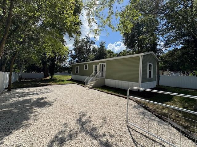 New 2 bedroom, 2 bath mobile home on its own lot in Brooksville, fully move-in ready with a home warranty included for peace of mind. This property features central heat and air, a fully fenced yard with privacy fencing, no carpet, vinyl flooring throughout, crown molding, and upgraded sheetrock walls. The kitchen boasts white shaker cabinets and stainless-steel appliances, including a side-by-side refrigerator with water and ice in the door. Primary suite includes bathroom and walk-in closet. Inside utility room with washer and dryer hookup. Home is connected to city water and offers modern finishes throughout—schedule your showing today.
