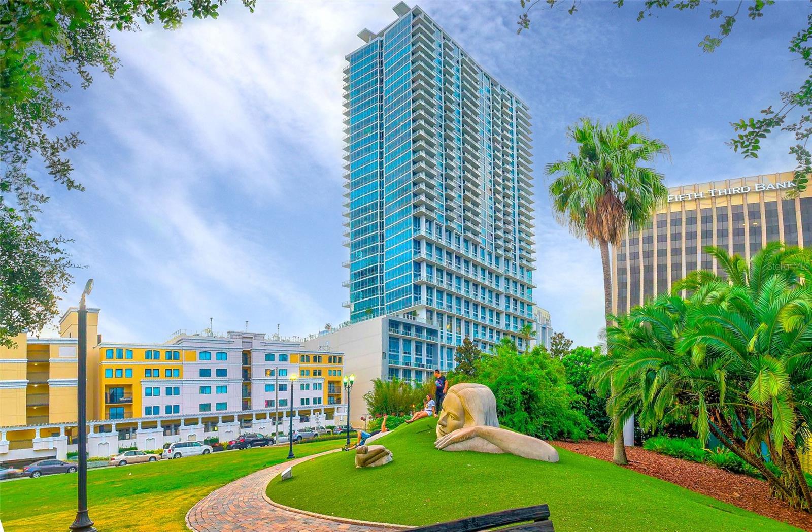 LAKESIDE 1 bedroom, 1.5-bathroom two-story loft in The Vue at Lake Eola. This unit has just been overhauled with new flooring and fresh paint throughtout! The first floor features Luxary wood flooring, an opening concept, plenty of additional closet space, and a half bath for guests! The kitchen is fully equipped and offers stainless steel appliances, granite counters, and a gas stove. Relax with views of the lake throughout. Walk out onto the balcony and enjoy Lake Eola or any outdoor concerts in the amphitheater. The living room also offers 27ft high floor to ceiling windows with automatic blinds. Once you climb the spiral staircase you will get to the
large loft that features a large full bathroom, huge walk in closet, and laundry room. It includes your own assigned parking spot and valet
parking for guests. Water, Sewer, and trash utilities INCLUDED IN THE RENT. The Vue offers the best amenities in downtown with a huge gym
loaded with anything you would need. Tennis Courts, basketball courts, and a heated rooftop pool. 24 hour security, biometric fingerprinting
access, concierge services, outdoor grills, a community theatre room, and a large community center with great views of the lake.
