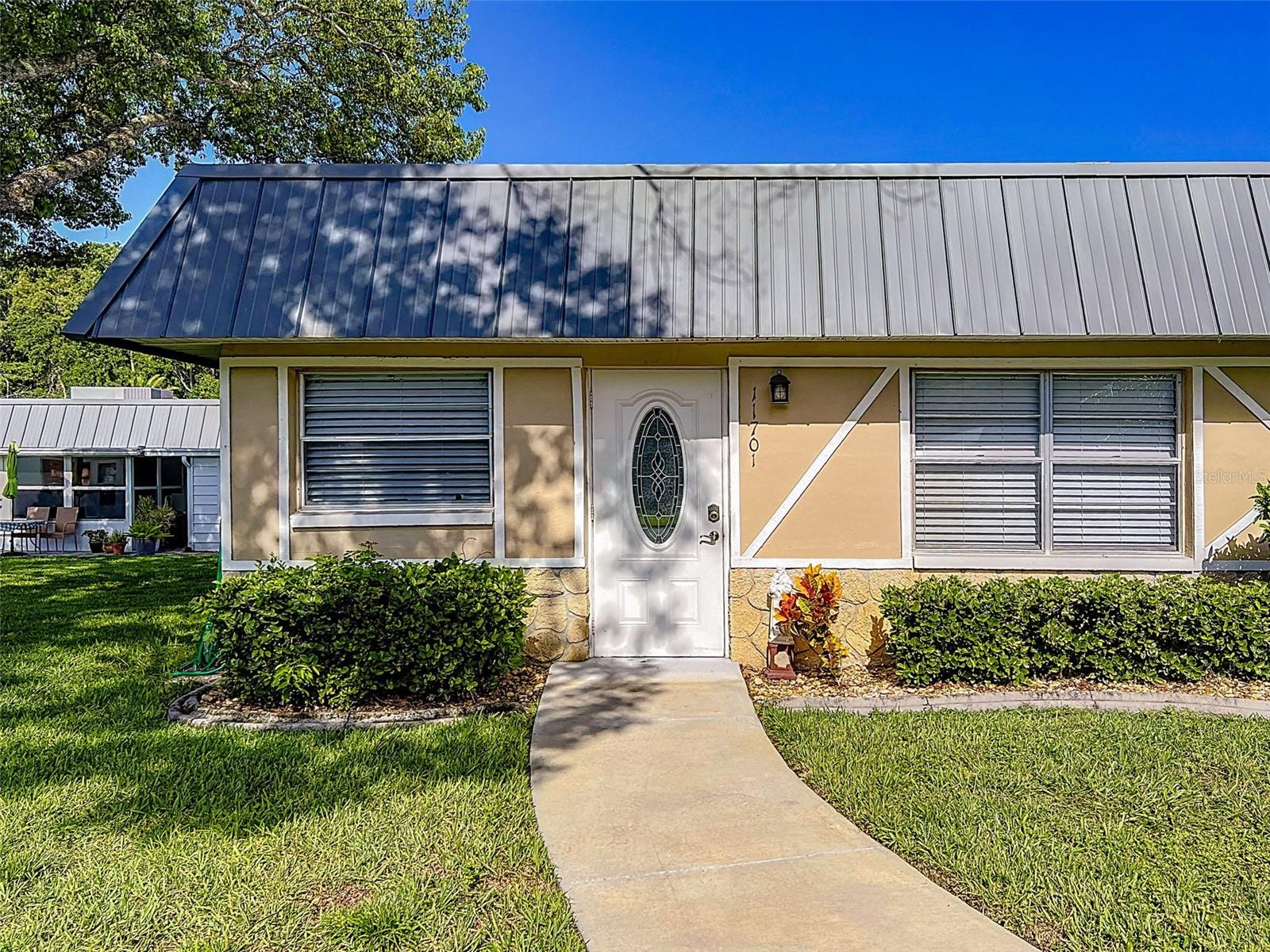The welcoming and active, pet friendly, 55+ community of Paradise Pointe in Summertree is where you want to be! This single-story 2 bedroom/2 bath condo is lovely and well maintained with covered parking, and a view of a park like setting across the street. Condo fee includes grounds and building maintenance (including roof), cable (including Disney+, HBO Max, Peacock, Paramount+, DVR), internet, trash pickup, and outside pest control. Activities abound in this community, the clubhouse contains a fitness center, sauna, steam room, pool, jacuzzi, card game room, billiards hall, media room, and library. Dances and shows are often offered in the large auditorium and if that isn't enough, there are also tennis, pickleball, and shuffleboard courts, bocci ball, horseshoes, plus a golf course, what more could you ask for?! Don't miss out on the chance to be part of this community and to make your new home your own personal oasis!! Furniture can be purchased separately.