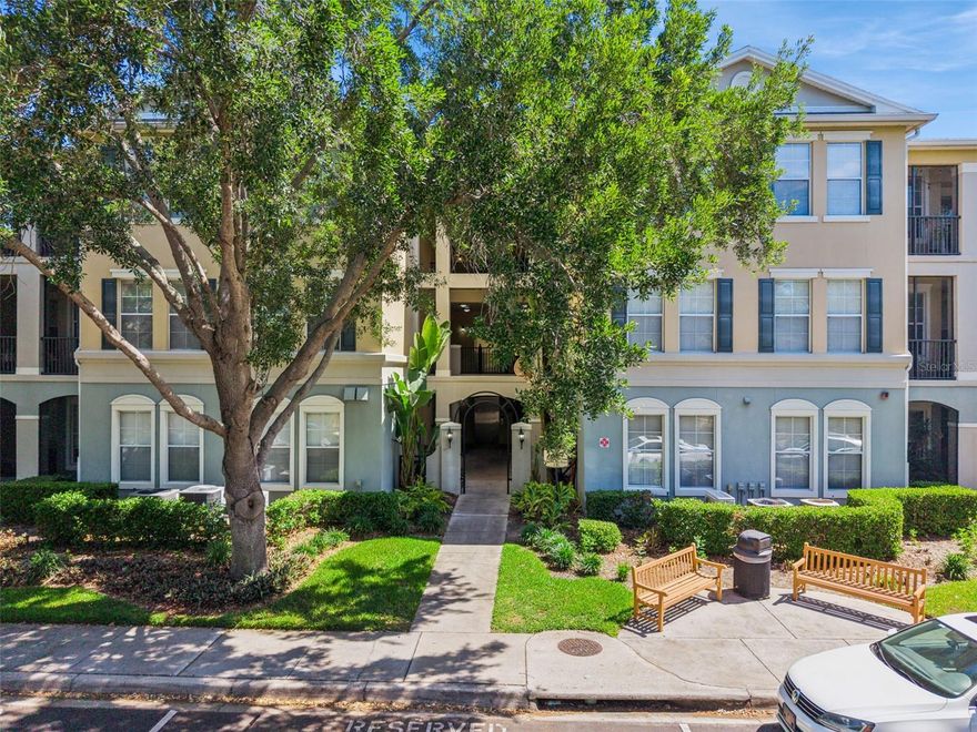 Located just 10 minutes from Disney's Magic Kingdom and Transportation and Ticket Center, welcome to this beautifully maintained FIRST FLOOR END UNIT in the highly sought after Lakeside at Lakes of Windermere. Move in ready and thoughtfully updated, this home offers a bright, open split floor plan with high ceilings and a light, neutral palette throughout. The home has been wired with high speed fiber optic internet, and association included valet trash, sewer, and water completes living with convenience. 

The kitchen has been tastefully upgraded with new FRIGIDAIRE GALLERY STAINLESS STEEL appliances, including a luxury INDUCTION RANGE, complemented by 42 inch wood cabinetry, a stainless steel backsplash, pantry, and bar seating that is perfect for everyday living or entertaining. The spacious owner’s suite is filled with natural light and offers a peaceful retreat, complete with a large walk in closet and an en suite bath featuring double sinks and a garden tub and shower combo. Secondary bedrooms are generously sized with one having an ensuite/shared bathroom, and the full size laundry closet adds everyday convenience. One of the standout features is the wraparound screened in porch where you can relax and enjoy the lush landscaping and mature oak trees, plus easy access to explore the beautifully maintained grounds or go fishing on Lake Burden. The amenities here truly stand out. Residents enjoy a resort style pool, tennis courts, fishing dock to LAKE BURDEN, clubhouse with full kitchen and gathering spaces, fitness center, beach volleyball court, outdoor fireplace, walking paths, playground, and more. With assigned parking, plus plenty of guest parking, and a prime location just across the street from Publix, dining options such as My French Cafe, Piesanos Stone Fired Pizza, Boteco do Manolo, and other great dining, shopping, top rated schools, and just minutes to Orlando’s world renowned theme parks, this is low maintenance living at its best.