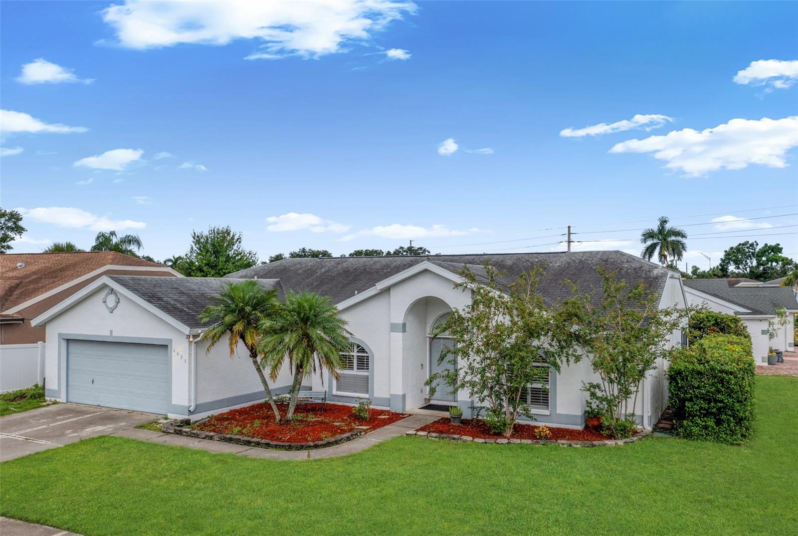Short Sale. Welcoming and full of potential, this 3-bedroom, 2-bath home offers almost 1,800 sq ft of comfortable living on a desirable corner lot with low HOA fees. Step inside to an open layout with soaring ceilings, abundant natural light, and warm wood floors that set the tone for easy everyday living. The kitchen is a highlight with stainless steel appliances, granite countertops, plenty of cabinetry, a tile backsplash, and a breakfast bar perfect for casual dining or entertaining. The spacious primary suite features two walk-in closets and a private bath with dual vanities, a garden tub, and a separate walk-in shower. Two additional bedrooms provide space for family, guests, or a home office. Enjoy Florida living year-round on the screened lanai, ideal for morning coffee or relaxing evenings. Conveniently located near I-75, shopping, dining, and schools, this home offers comfort, functionality, and a great location! **THIS PROPERTY QUALIFIES FOR A 1% LENDER INCENTIVE IF USING PREFERRED LENDER. INQUIRE FOR MORE DETAILS.**