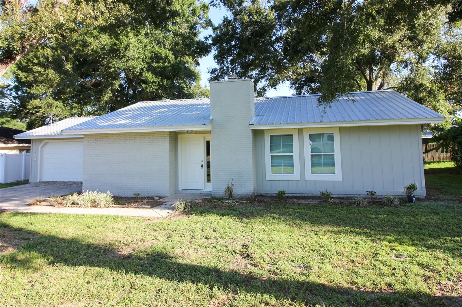 3 Bedrooms, 2 Bathrooms, & 2 Car Garage home located in SE Lakeland with No HOA! Located on a quiet street just minutes from shopping, Polk Parkway and Bartow Hospital. Whole house features tile floors and has been freshly painted. The 3 seasons back patio has screens and closing glass, with a space to add a portable a/c unit. Back yard is fully fenced with a large oak tree providing lots of shade.
