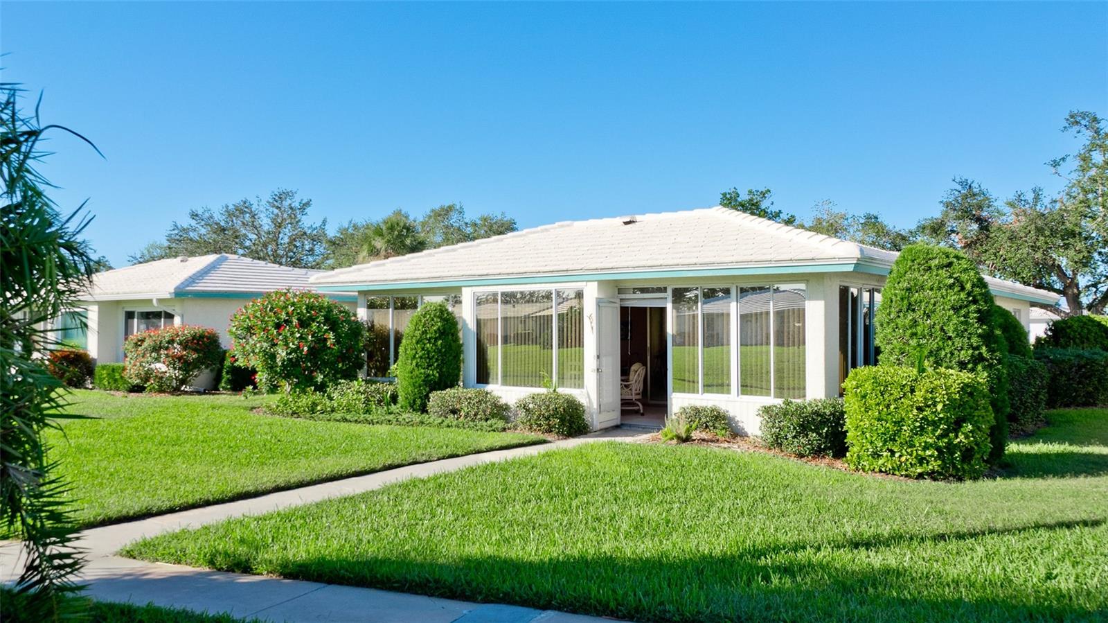 Welcome to your dream retreat in the highly desirable Village Green community of Bradenton, Florida! This well-maintained 2-bedroom, 2-bathroom home, with a bonus room and 2-car garage, boasts 1,825 square feet of comfortable living space designed for relaxation and entertainment. Step into a bright and spacious living area featuring an open layout that flows seamlessly into the dining room, kitchen, and bonus room. The kitchen is open and spacious with easy access to the laundry room and garage. From the back entrance to the neighborhood pool, walking paths, and shuffleboard courts are less than a minute's walk. The primary bedroom offers a tranquil escape with a private bathroom and generous closet space, while the second bedroom provides flexibility for guests, a home office, or a hobby room. The second bathroom is conveniently located and thoughtfully designed. The home’s location in the tranquil Village Green neighborhood puts you close to Bradenton’s beautiful beaches, shopping, dining, and entertainment. Don’t miss this opportunity to own a piece of paradise in a community known for its charm, open and abundant green spaces, and prime location. Schedule your showing today!