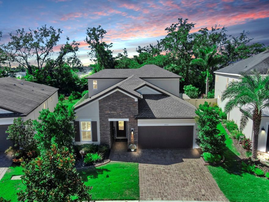 Welcome home to the gated community of Mariposa! This Meritage Foxtail floorplan (built in 2017) shows like a model, offering thoughtful upgrades and pride of ownership throughout. Situated on an oversized ¼+ acre lot with peaceful conservation views, this 5-bedroom, 3-bath home includes an upstairs game room, and an upgraded 40-foot covered lanai—perfect for Florida living. Recent upgrades make this home truly move-in ready: a brand-new roof, newly sealed pavers in both the front and back of the home, freshly sealed stone accents on the exterior, a new water softener, new exterior paint with rain refresh technology, newly painted and sealed pergola, and upgraded lighting fixtures throughout. Inside, the open floor plan begins with a welcoming elongated hallway leading to the spacious kitchen and living areas. This gourmet kitchen boasts quartz countertops, stainless steel appliances, 42-inch wood cabinets, a double oven, cooktop, and a large island that flows seamlessly into the dining and family rooms. The owner’s suite features a tray ceiling, walk-in closets, dual vanities, and large shower and soaking tub. Upstairs, the bonus/game room offers flexibility for a playroom, media space, or home gym or in-law suite. Step outside to your private oasis and enjoy the oversized backyard with a hot tub, plenty of room for a pool, and serene conservation views. The gated Mariposa community offers resort-style amenities including a pool, clubhouse, playground, indoor/outdoor entertaining areas with grills, and bar space. Conveniently located near top-rated schools, restaurants, shopping, I-75, the Crosstown Expressway, and US-301. Don’t miss your chance to own this beautifully upgraded home—schedule your private showing today!