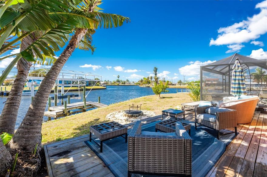 Welcome boaters! This beautifully updated GULF ACCESS home sits on a desirable oversized tip lot and features two docks, a 10,000 lb boat lift, and about 10 minutes to open water by boat. With expanded water frontage and stunning views from multiple angles, this fully furnished 3 bedroom, 2 bathroom home is ready for you to start enjoying the Florida boating lifestyle. The interior features an open floor plan connecting the living room, dining area, and updated kitchen with granite countertops, new cabinetry, stainless steel appliances, ceramic tile flooring, and sliding doors that lead directly to the lanai and pool area. Both bathrooms have been tastefully updated with tiled showers and granite, and the home also includes a new washer and dryer along with a new roof installed in 2023. Many of the major updates have already been completed, allowing the next owner to simply move in and enjoy. Step outside and enjoy true Florida outdoor living with a heated pool, new pool cage and screens, a relaxing hot tub, and a spacious lanai and pool deck perfect for entertaining or simply enjoying the waterfront views. A covered side porch just off the kitchen provides a shaded retreat, while an additional open deck beside the mature traveler's palm is the perfect place to soak up the sun or enjoy evenings around the firepit. The property also features a paver driveway that continues into the covered two car carport and a storage shed for extra storage. Conveniently located near restaurants, shopping, and entertainment, this move-in ready waterfront home offers everything needed for boating, relaxing, and enjoying the best of Southwest Florida living. Imagine stepping outside, lowering your boat from the lift, and being on open water in about 10 minutes. Schedule your private showing today.