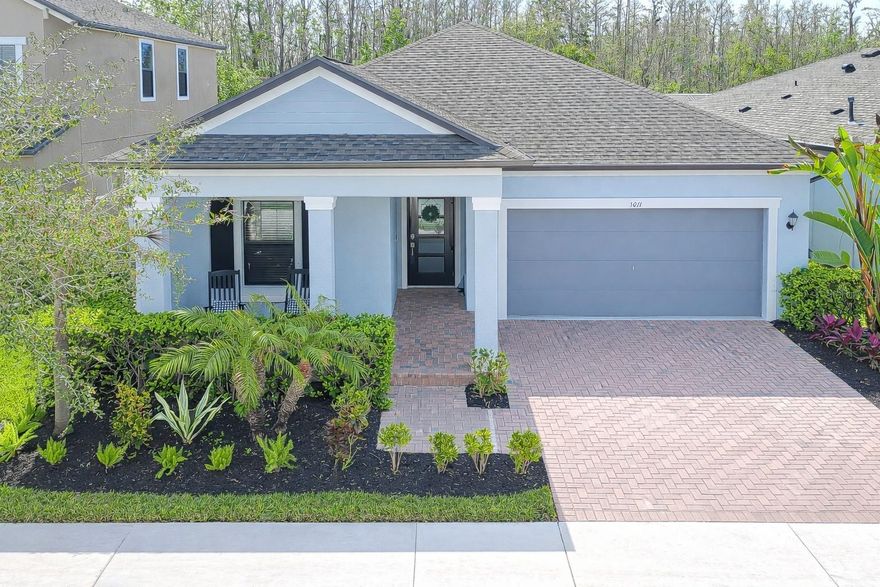 Welcome to your dream home in Bexley, one of Pasco County’s most sought-after communities! This beautiful 4-bedroom, 3-bathroom residence seamlessly combines style, comfort, and functionality. Step into the inviting foyer, as you continue into the home, you’re naturally guided toward the heart of the living space. The chef-inspired kitchen is a showstopper, boasting Cambria Quartz countertops, stainless LG appliances—including a gas stove and oven—and under-cabinet lighting. A spacious island with a deep utility sink, dishwasher, and pendant lighting creates the perfect space for cooking, entertaining, or casual dining. The large pantry ensures plenty of storage for all your culinary needs. The expansive family and dining rooms flow effortlessly from the kitchen, offering abundant space for gatherings and everyday living. The luxurious owner’s suite is tucked away for privacy and features a tray ceiling, a generous walk-in closet, and a spa-like bathroom with a large walk-in shower, soaking tub, and dual-sink vanity. A convenient second door connects the owner’s bath to the laundry room, streamlining household routines. Two additional bedrooms sit at the front of the home that are spacious in size and offer tons of flexibility to be a private home office, play room, private guest suite, or in- law suite, as there is a beautiful lit frosted sliding door that turns the wing private. while the second bedroom sits on its own private hallway with a full bath, offering comfort and separation for guests or family members. Plus, the home is just a short walk to the elementary school, making mornings a breeze for families. Enjoy serene mornings or evenings on your oversized lanai overlooking a peaceful conservation area that will remain undeveloped—your private outdoor sanctuary all year long. Bexley offers an award-winning lifestyle with resort-style amenities, including two pools, a café, fitness center, indoor and outdoor fireplaces, a game room, bike park with trails, and a dog park. Perfectly located near Suncoast Parkway, this home provides easy access to Tampa International Airport, downtown Tampa, shopping, dining, and more.